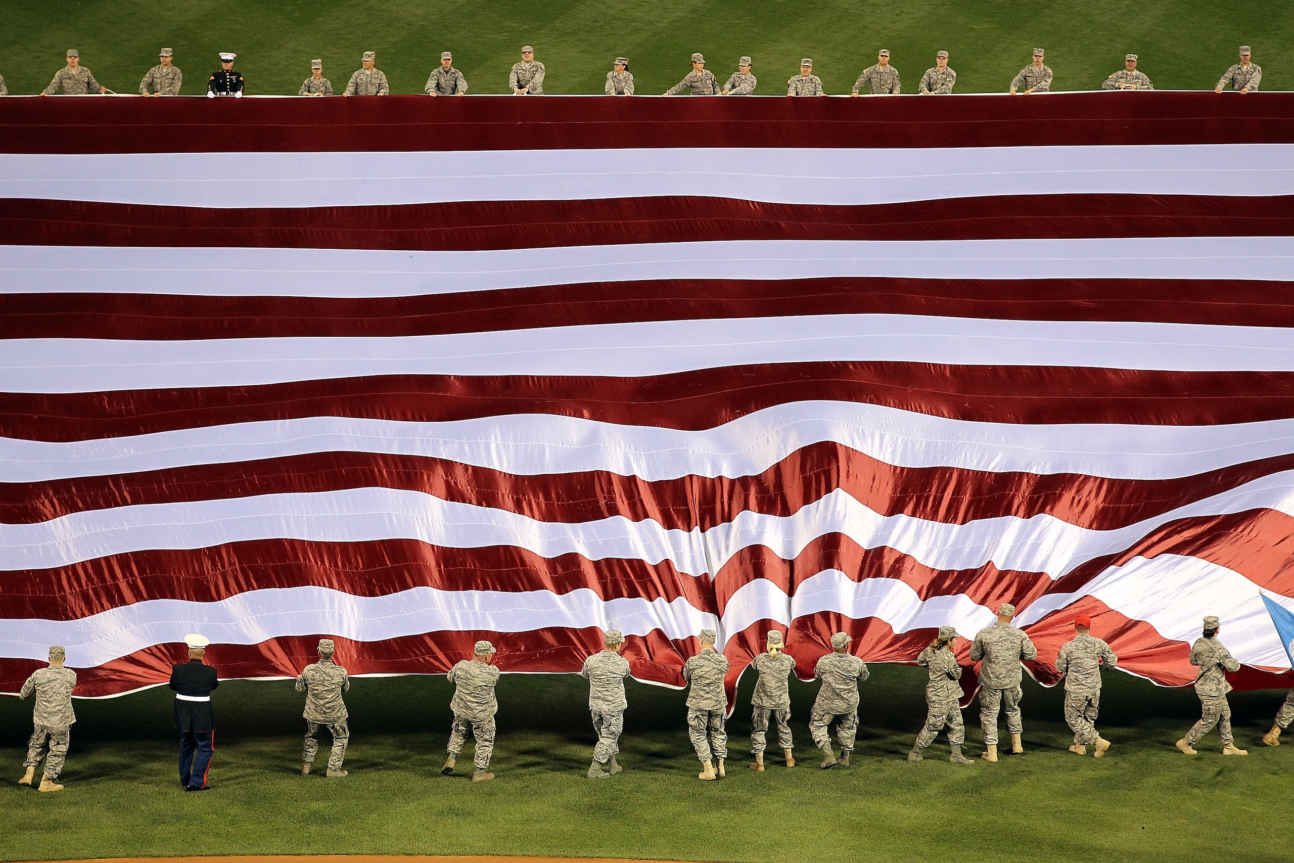PHILADELPHIA - OCTOBER 16:  The American flag is displayed in the outfield during the singing of the national anthem before Game One of the NLCS during the 2010 MLB Playoffs between the San Francisco Giants and the Philadelphia Phillies at Citizens Bank P