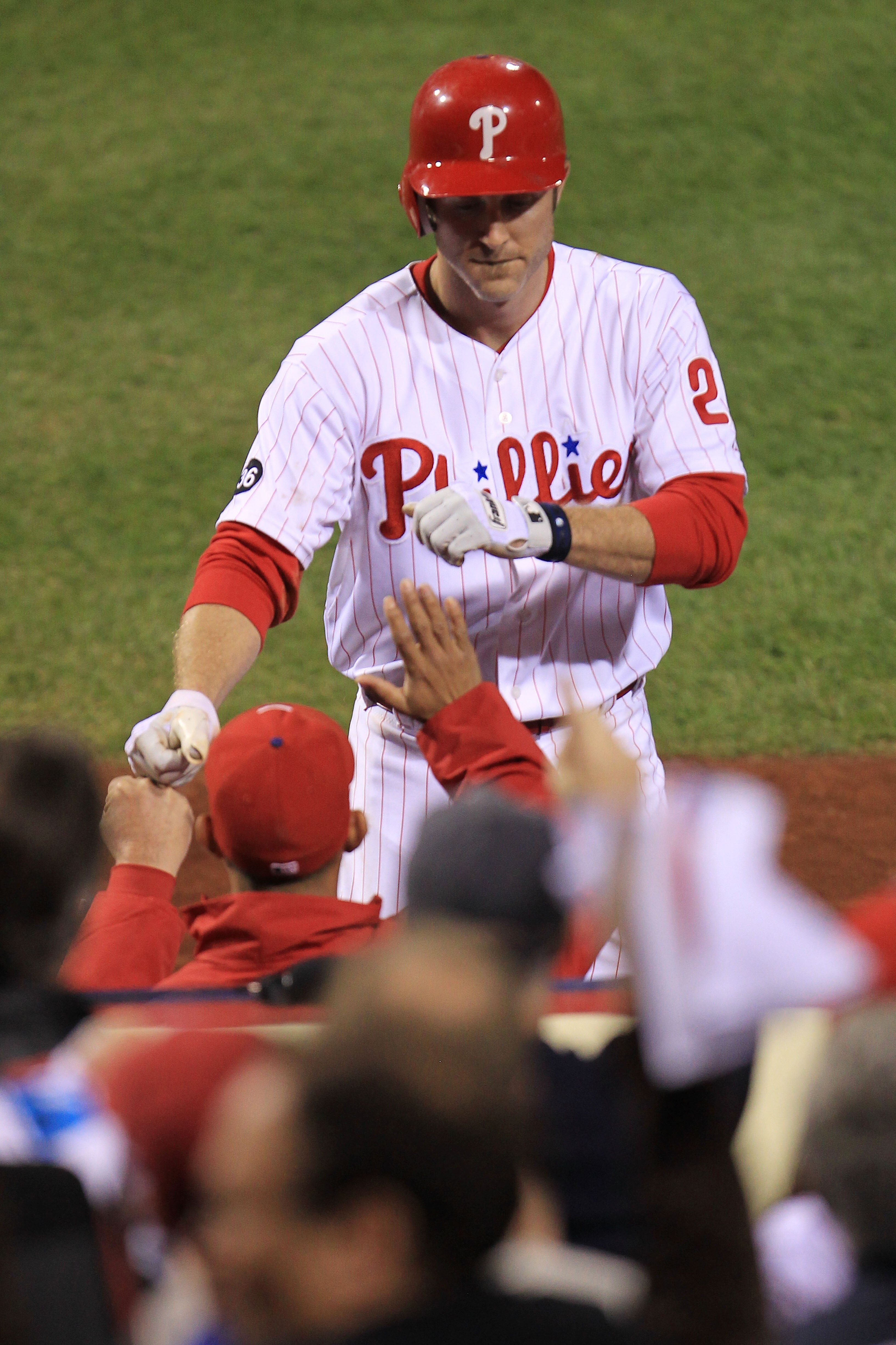 PHILADELPHIA - OCTOBER 17:  Chase Utley #26 of the Philadelphia Phillies celebrates being walked home for the Phillies' first run in the first inning against the San Francisco Giants in Game Two of the NLCS during the 2010 MLB Playoffs at Citizens Bank Pa