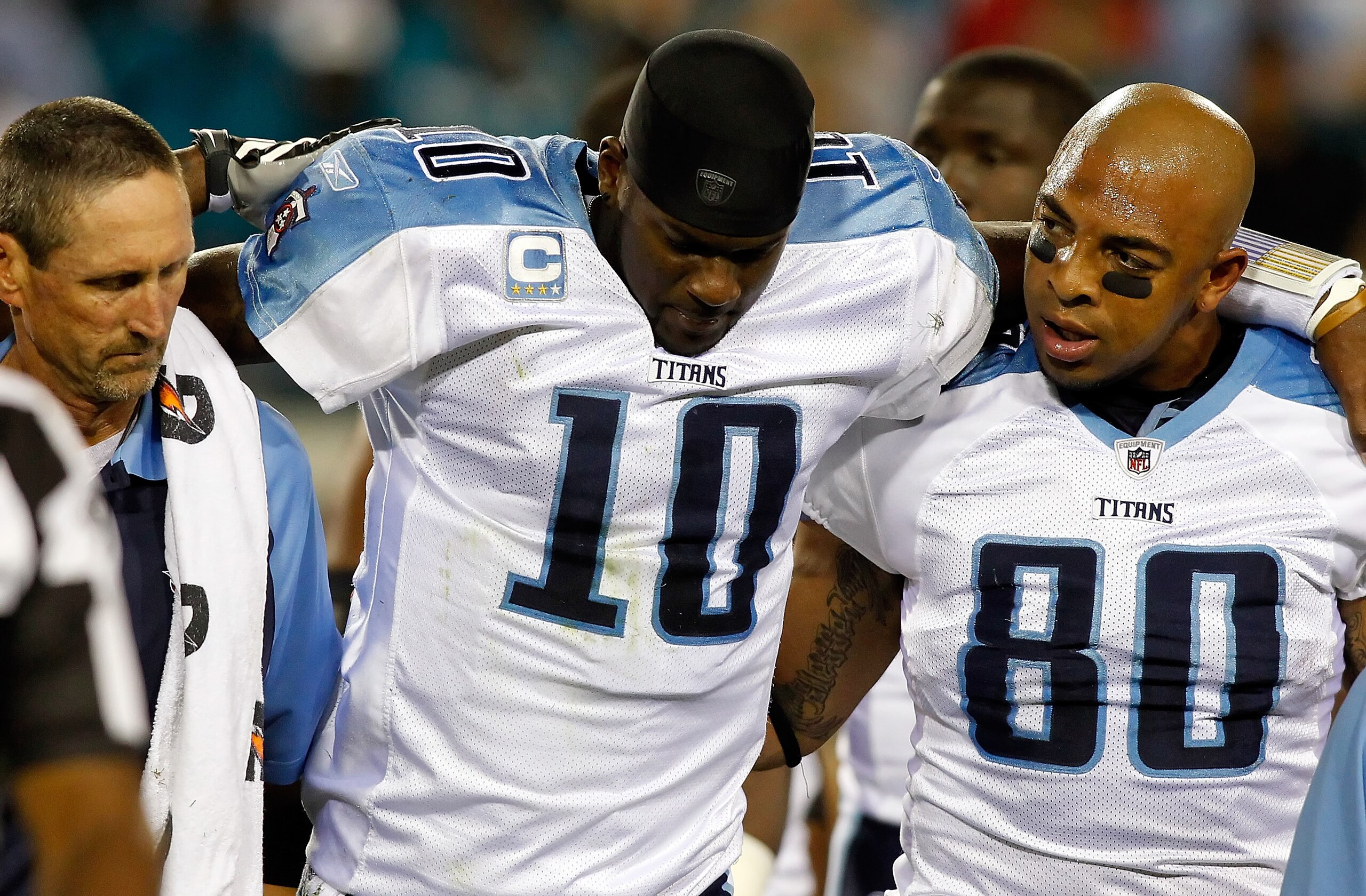 JACKSONVILLE, FL - OCTOBER 18:  Quarterback Vince Young #10 of the Tennessee Titans is helped from the field during the first quarter against the Jacksonville Jaguars during the game at EverBank Field on October 18, 2010 in Jacksonville, Florida.  (Photo