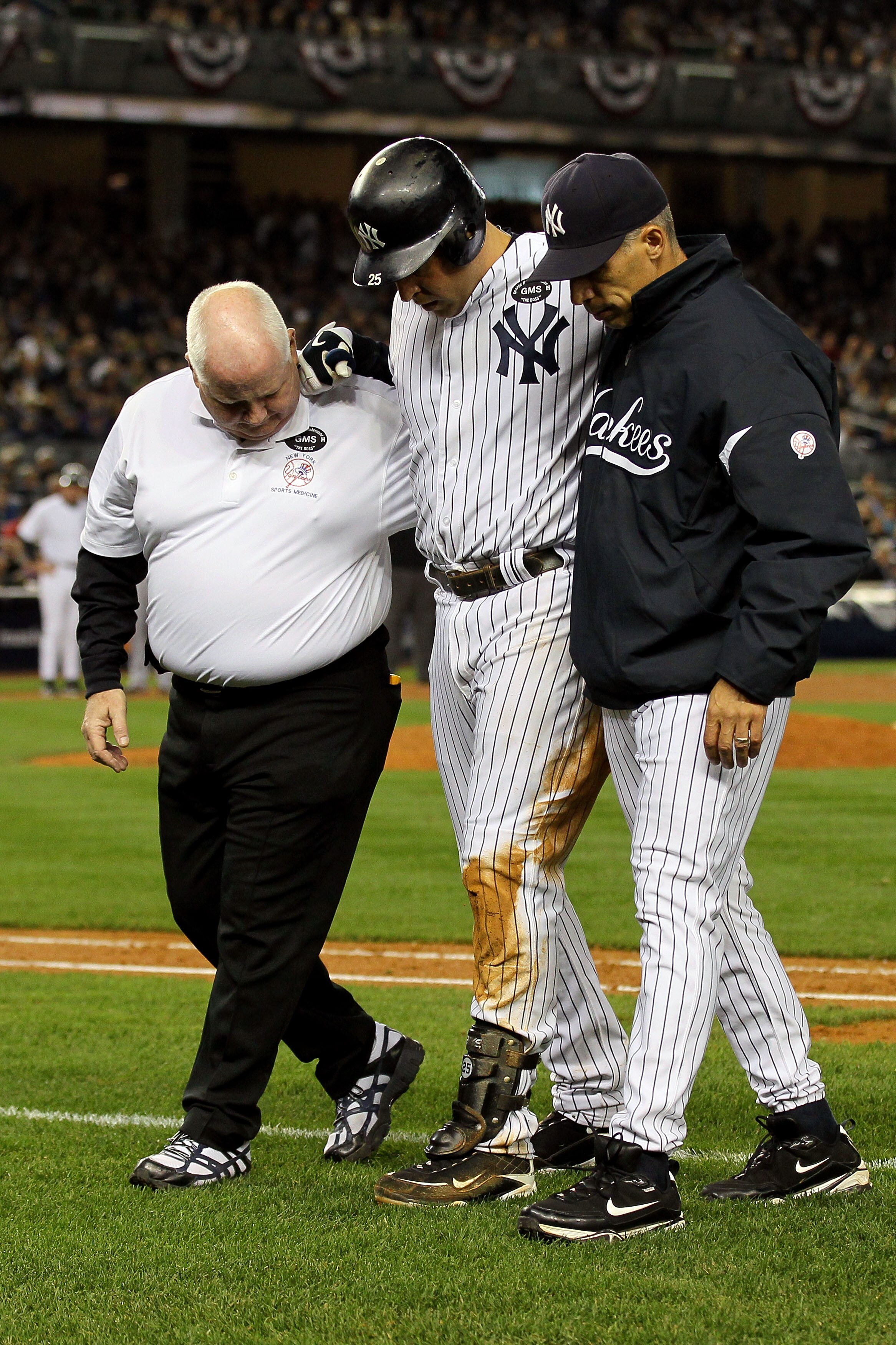 NEW YORK - OCTOBER 19:  Mark Teixeira #25 of the New York Yankees is helped off of the field by Manager Joe Girardi and a trainer after hurting himself while playing against the Texas Rangers in Game Four of the ALCS during the 2010 MLB Playoffs at Yankee