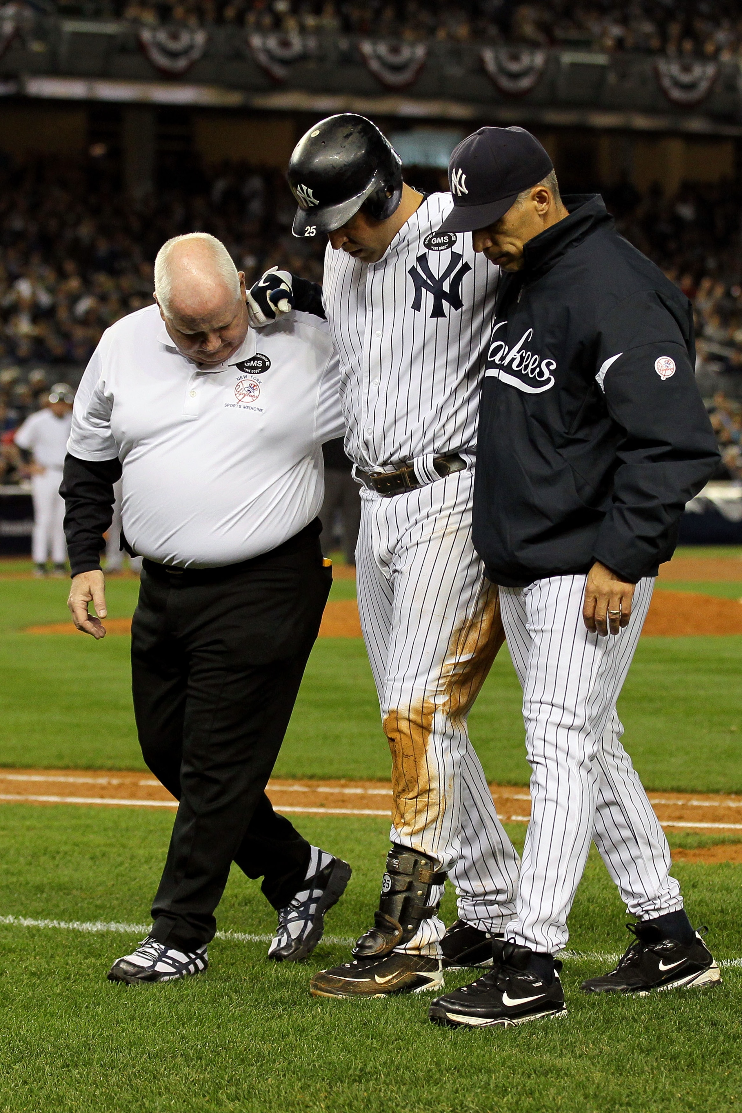 NEW YORK - OCTOBER 19:  Mark Teixeira #25 of the New York Yankees is helped off of the field by Manager Joe Girardi and a trainer after hurting himself while playing against the Texas Rangers in Game Four of the ALCS during the 2010 MLB Playoffs at Yankee
