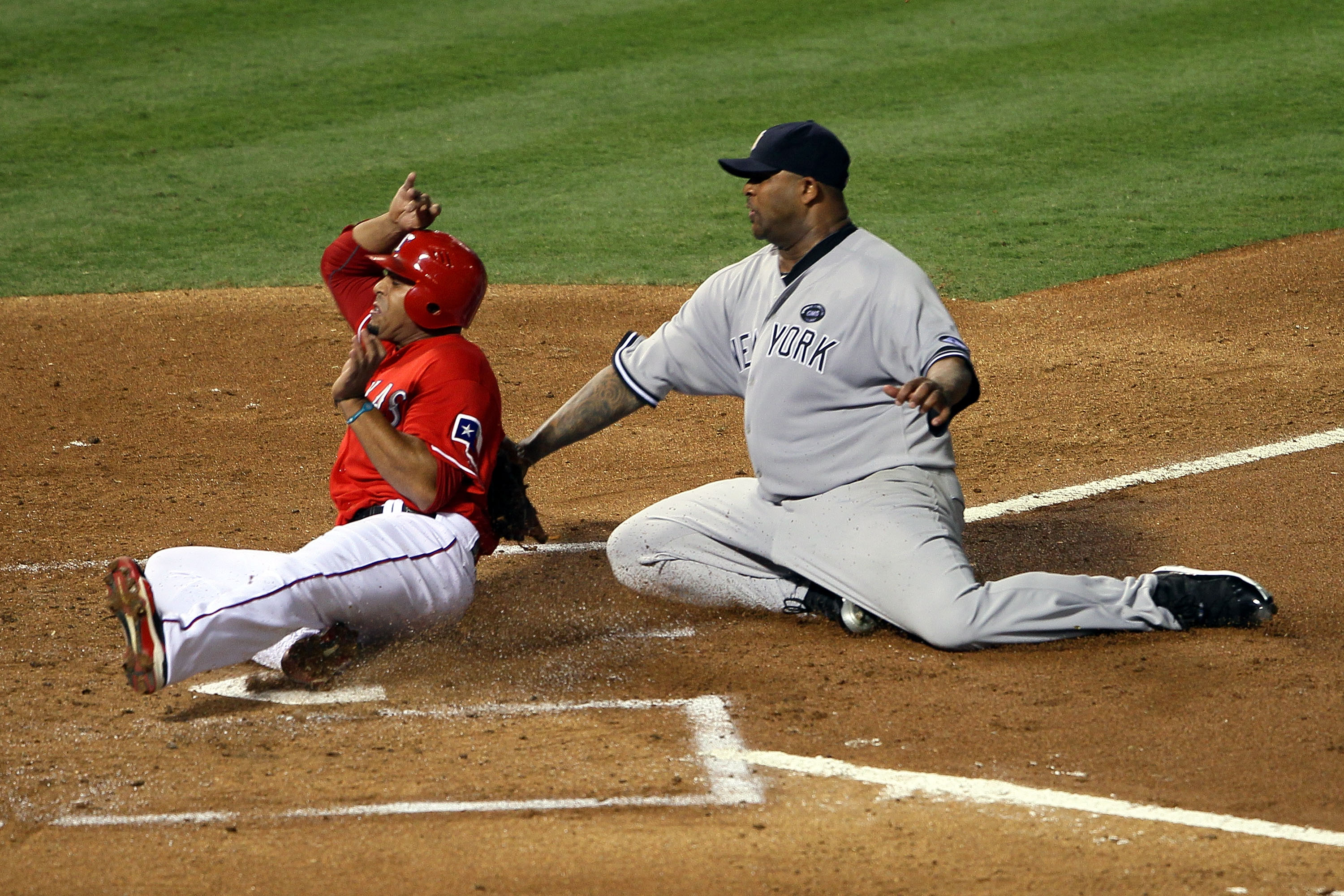 ARLINGTON, TX - OCTOBER 15:  CC Sabathia #52 of the New York Yankees tags out Nelson Cruz #17 of the Texas Rangers at the plate in Game One of the ALCS during the 2010 MLB Playoffs at Rangers Ballpark in Arlington on October 15, 2010 in Arlington, Texas.