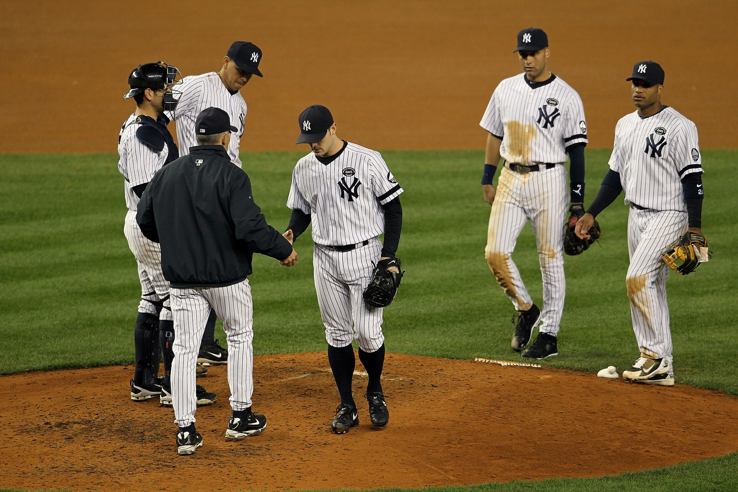NEW YORK - OCTOBER 19: David Robertson #30 of the New York Yankees is pulled out of the game by manager Joe Girardi as Nick Swisher #33, Robinson Cano #24, Derek Jeter #2 and Alex Rodriguez #13 look on against the Texas Rangers in Game Four of the ALCS d NEW YORK - OCTOBER 19: David Robertson #30 of the New York Yankees is pulled out of the game by manager Joe Girardi as Nick Swisher #33, Robinson Cano #24, Derek Jeter #2 and Alex Rodriguez #13 look on against the Texas Rangers in Game Four of the ALCS d