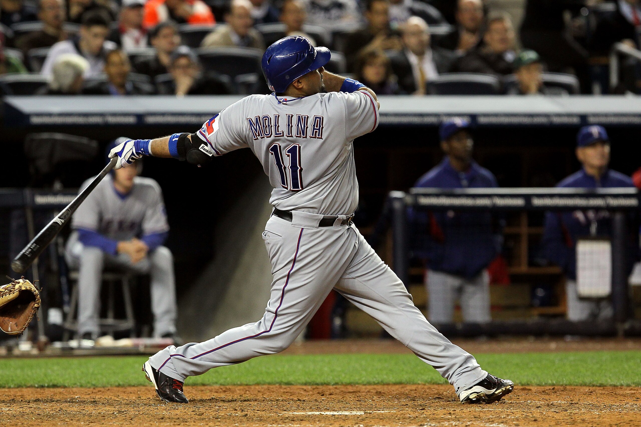 NEW YORK - OCTOBER 19: Bengie Molina #11 of the Texas Rangers hits a three-run home run in the top of the sixth inning against A.J. Burnett #34 of the New York Yankees in Game Four of the ALCS during the 2010 MLB Playoffs at Yankee Stadium on October 19 NEW YORK - OCTOBER 19: Bengie Molina #11 of the Texas Rangers hits a three-run home run in the top of the sixth inning against A.J. Burnett #34 of the New York Yankees in Game Four of the ALCS during the 2010 MLB Playoffs at Yankee Stadium on October 19
