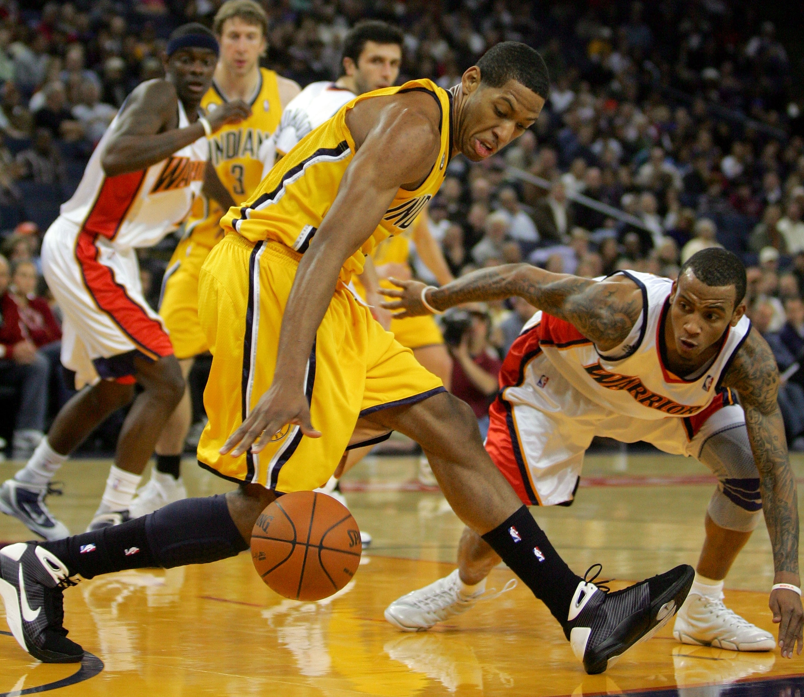 OAKLAND, CA - NOVEMBER 30:  Danny Granger #33 of the Indiana Pacers tries to keep the ball away from Monta Ellis #8 of the Golden State Warriors at Oracle Arena on November 30, 2009 in Oakland, California.  NOTE TO USER: User expressly acknowledges and ag