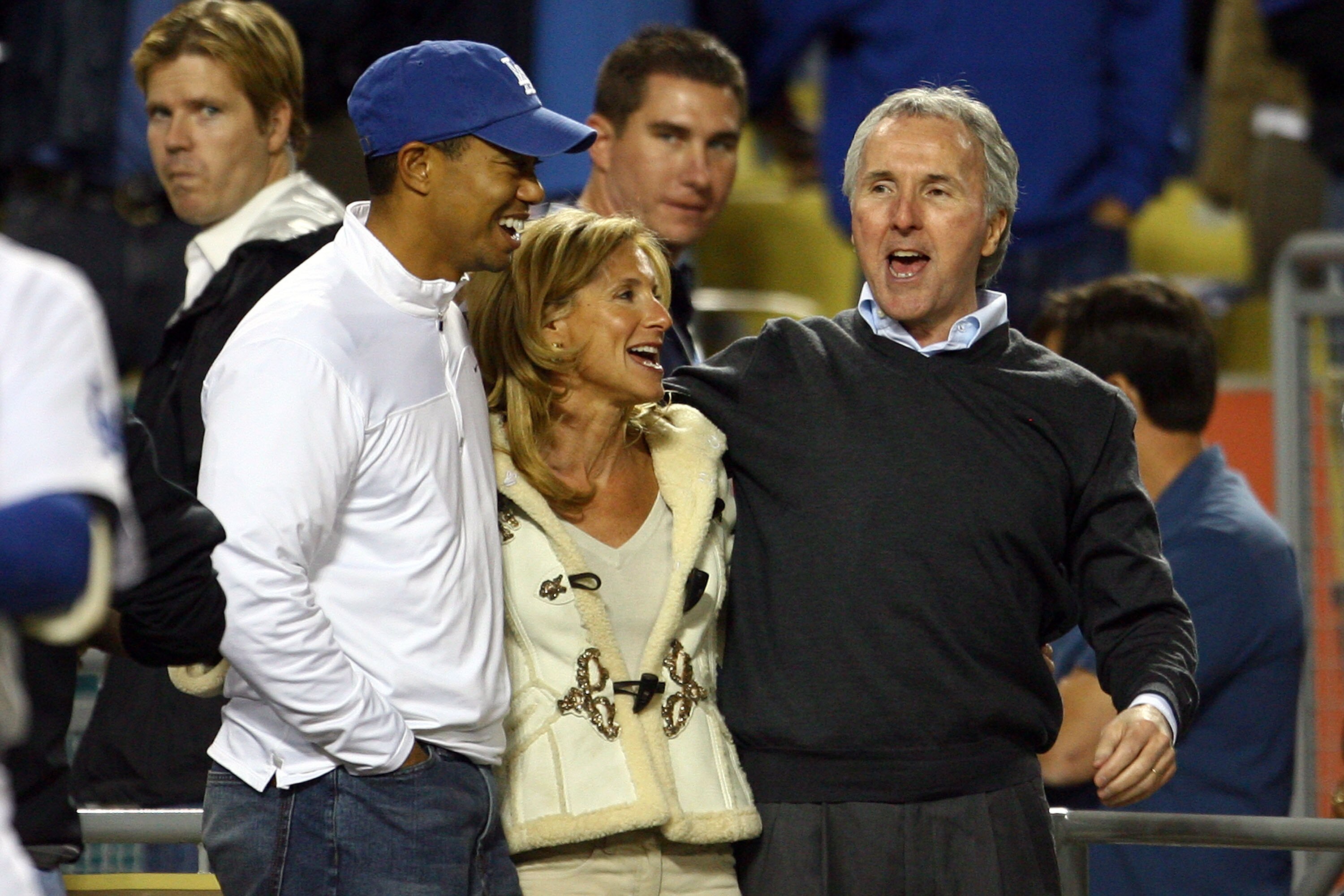 LOS ANGELES, CA - OCTOBER 12:  (L) Golfer Tiger Woods stands with owner (R) Frank McCourt of the Los Angeles Dodgers and wife Jamie McCourt who is the vice chairman and president of the Dodgers as they take on the Philadelphia Phillies in Game Three of th