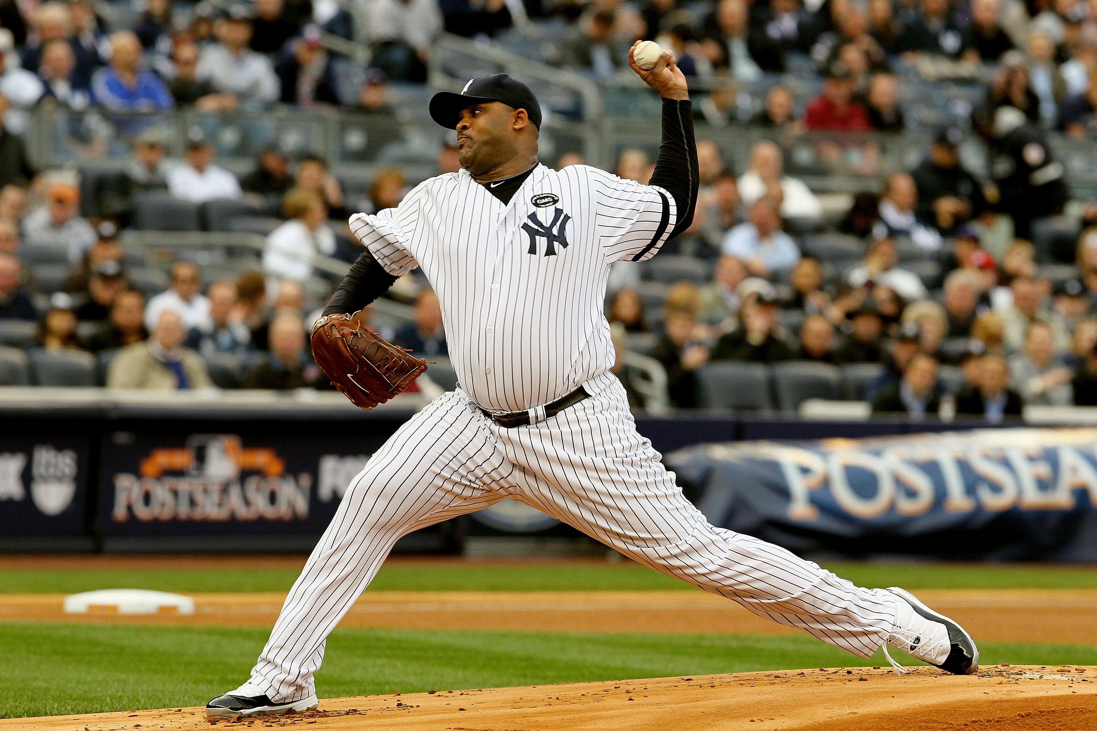 NEW YORK - OCTOBER 20:  CC Sabathia #52 of the New York Yankees pitches against the Texas Rangers in Game Five of the ALCS during the 2010 MLB Playoffs at Yankee Stadium on October 20, 2010 in the Bronx borough of New York City.  (Photo by Jim McIsaac/Get