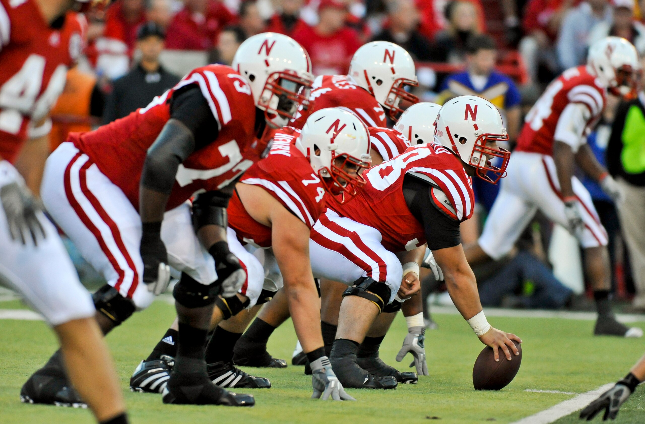 LINCOLN, NEBRASKA - SEPTEMBER 25: The Nebraska Cornhuskers offensive line, centered by offensive linesman Mike Caputo #58 lines up against the South Dakota State Jackrabbits during first half action of their game at Memorial Stadium on September 25, 2010 