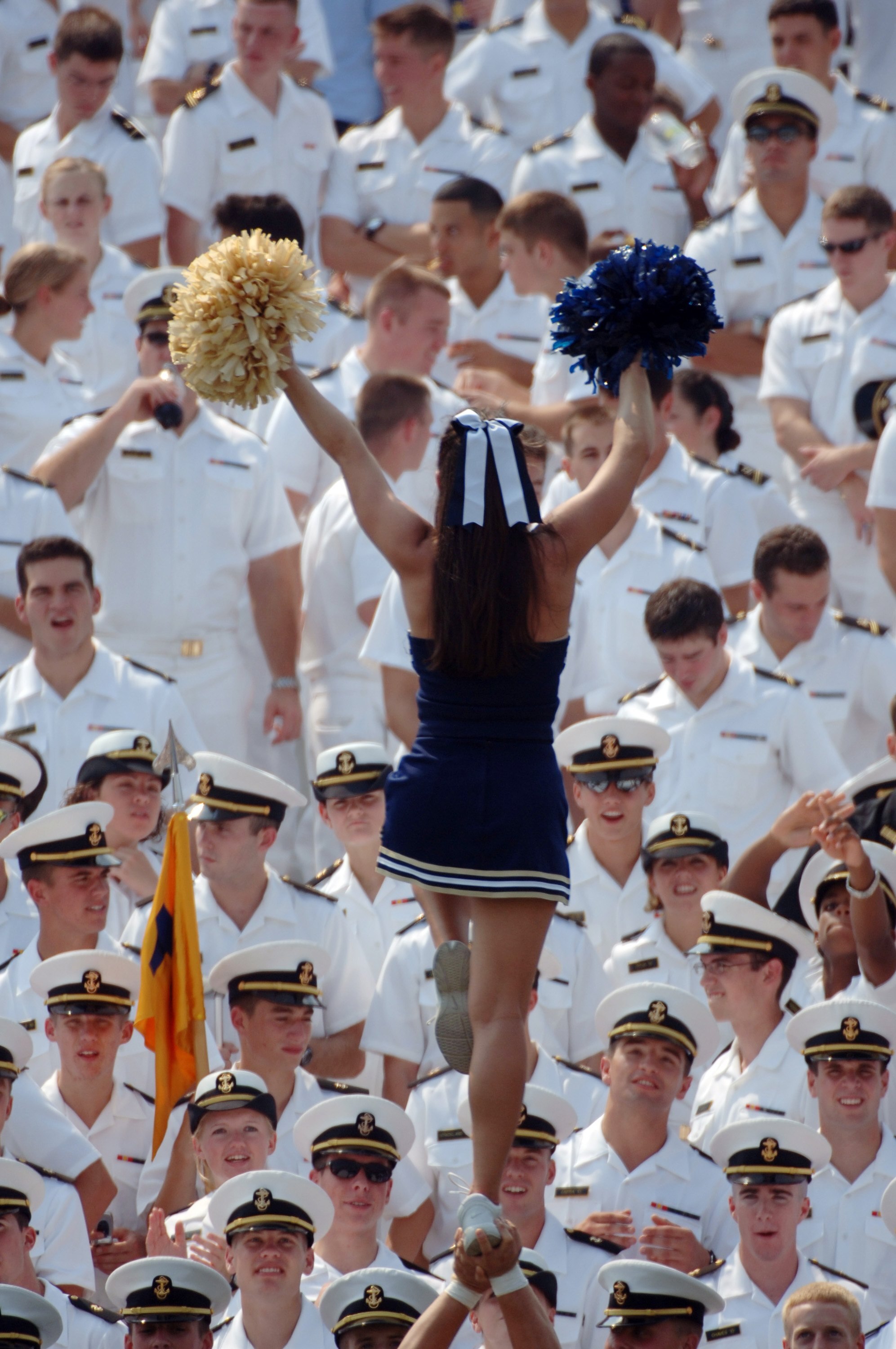 ANNAPOLIS, MD - SEPTEMBER 9:  In this handout provided by the U.S. Navy, A cheerleader does her routine during the game between the Massachusetts Minutemen and Navy Midshipmen on September 9, 2006 at Navy Memorial Stadium in Annapolis, Maryland. The Navy