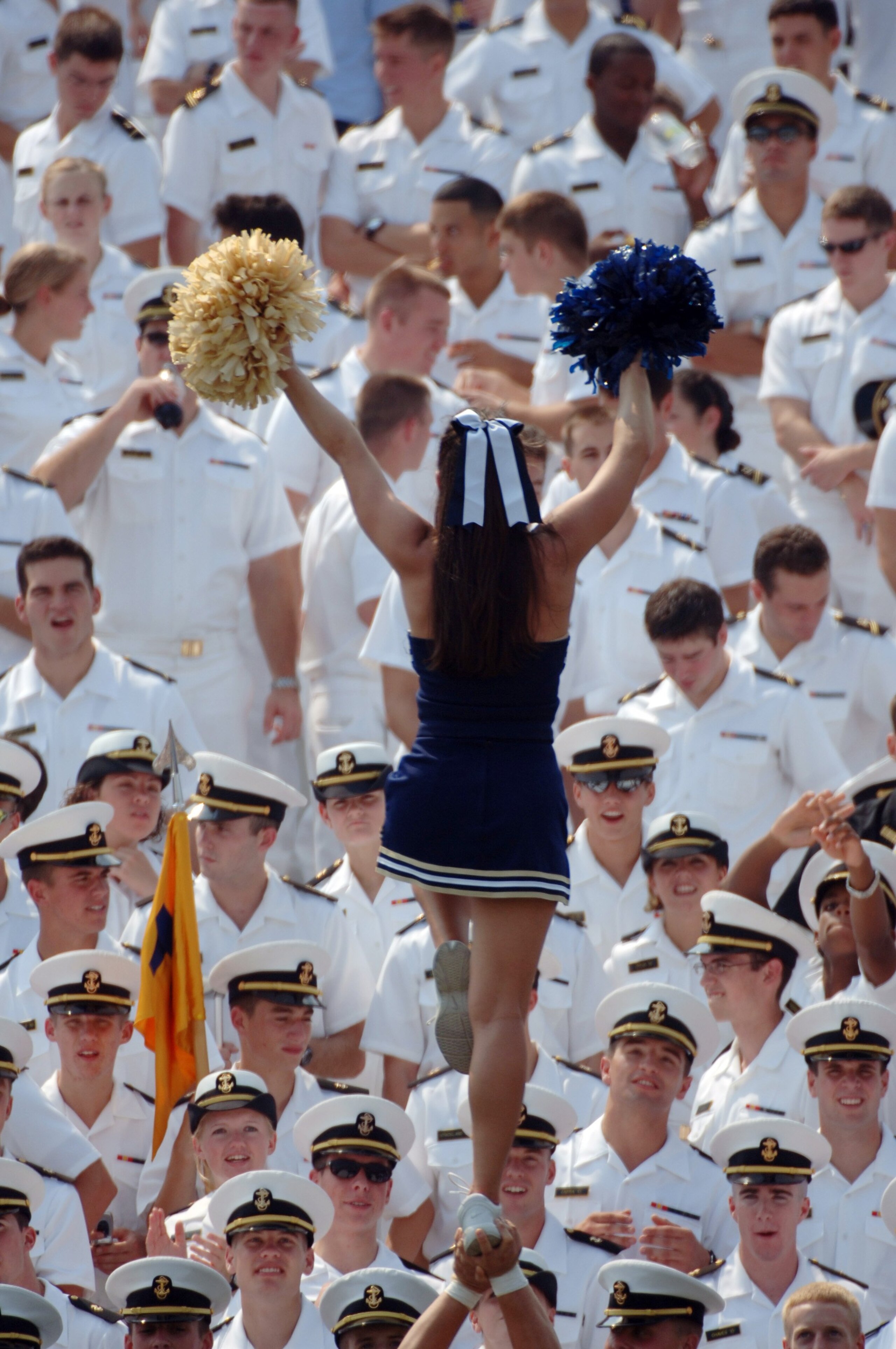 ANNAPOLIS, MD - SEPTEMBER 9:  In this handout provided by the U.S. Navy, A cheerleader does her routine during the game between the Massachusetts Minutemen and Navy Midshipmen on September 9, 2006 at Navy Memorial Stadium in Annapolis, Maryland. The Navy