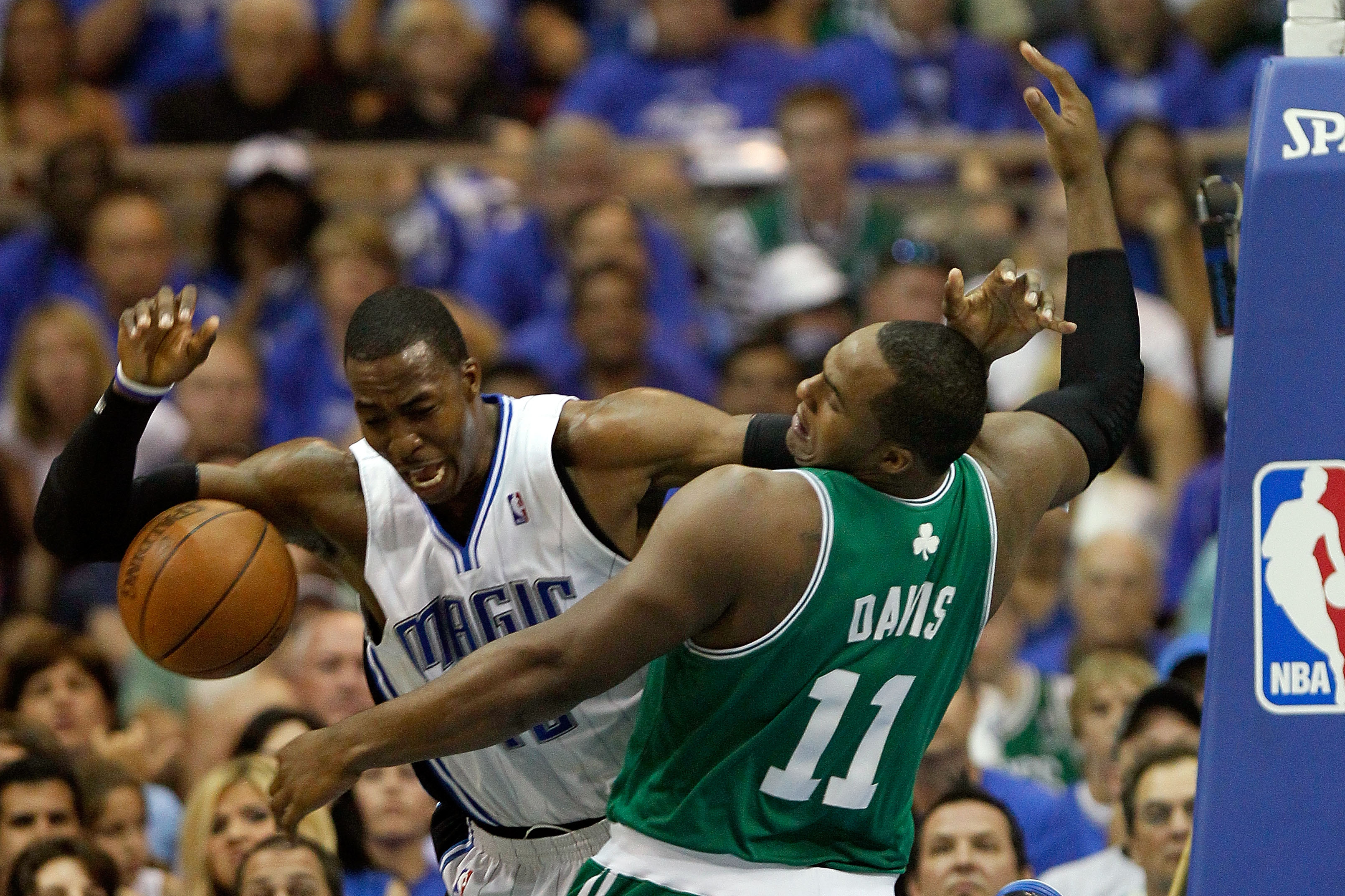 ORLANDO, FL - MAY 16:  Dwight Howard #12 of the Orlando Magic loses the ball as he is defended by Glen Davis #11 of the Boston Celtics in the first quarter of Game One of the Eastern Conference Finals during the 2010 NBA Playoffs at Amway Arena on May 16,
