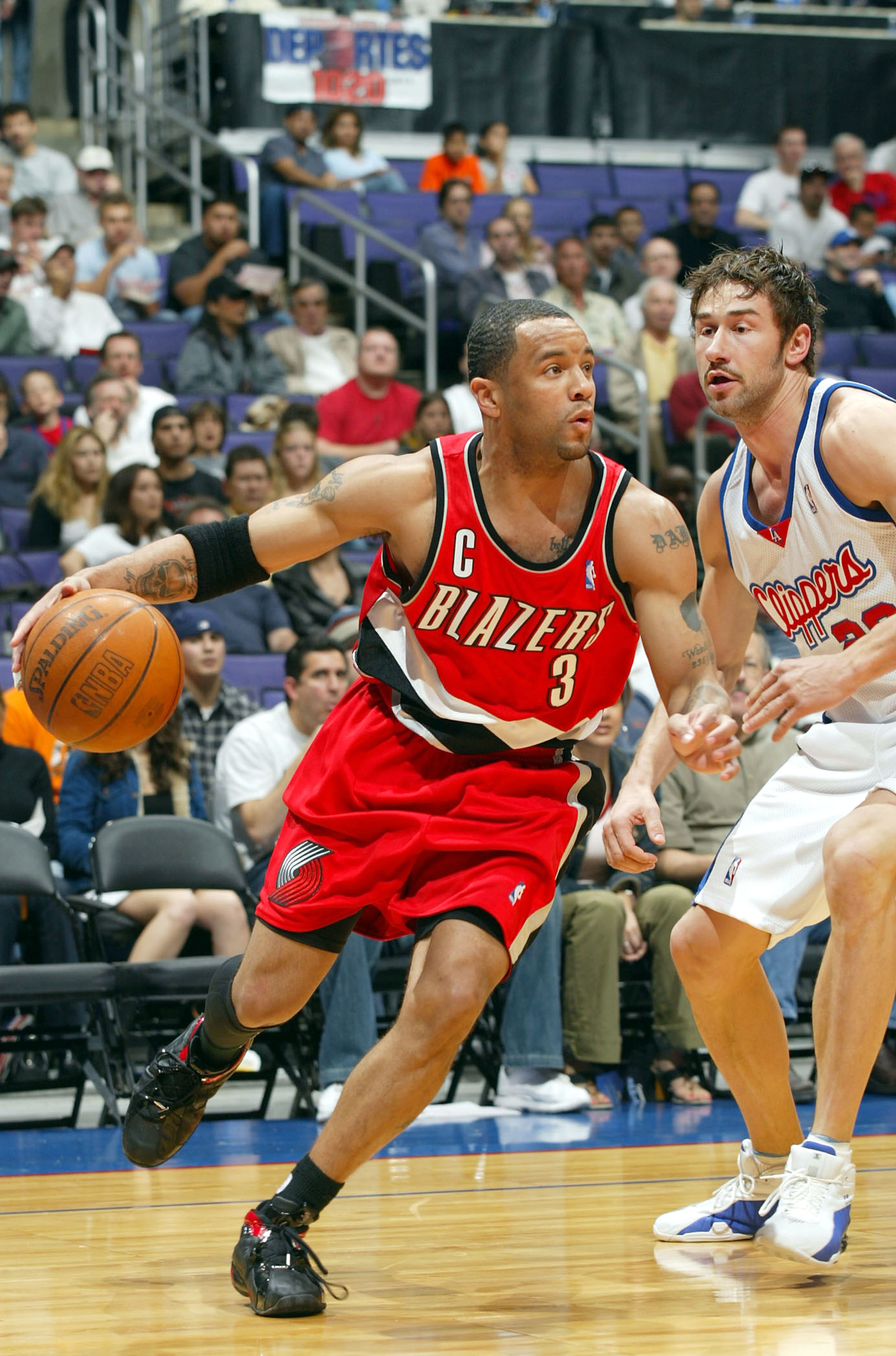 LOS ANGELES - MARCH 7: Damon Stoudamire #3 of the Portland Trail Blazers drives to the basket past Marko Jaric #20 of the Los Angeles Clippers during the game at Staples Center on March 7, 2004 in Los Angeles, California. NOTE TO USER: User expressly ac LOS ANGELES - MARCH 7: Damon Stoudamire #3 of the Portland Trail Blazers drives to the basket past Marko Jaric #20 of the Los Angeles Clippers during the game at Staples Center on March 7, 2004 in Los Angeles, California. NOTE TO USER: User expressly ac
