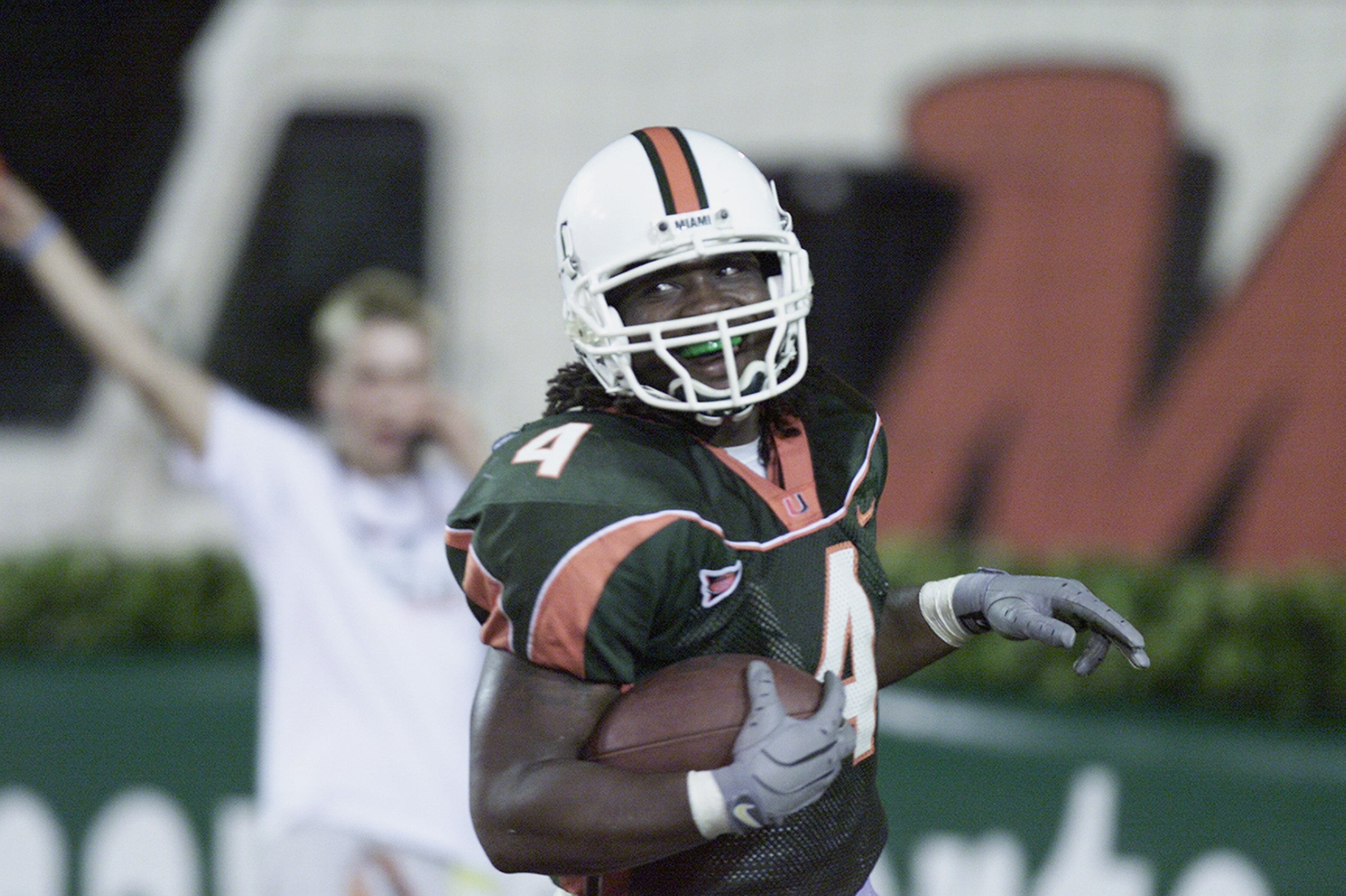 MIAMI - NOVEMBER 17:  Running back Najeh Davenport #4 of the Miami Hurricanes scores a touchdown during the Big East Conference football game against the Syracuse Orangemen at the Orange Bowl on November 17, 2001 in Miami Florida.  Miami won 59-0.  (Photo