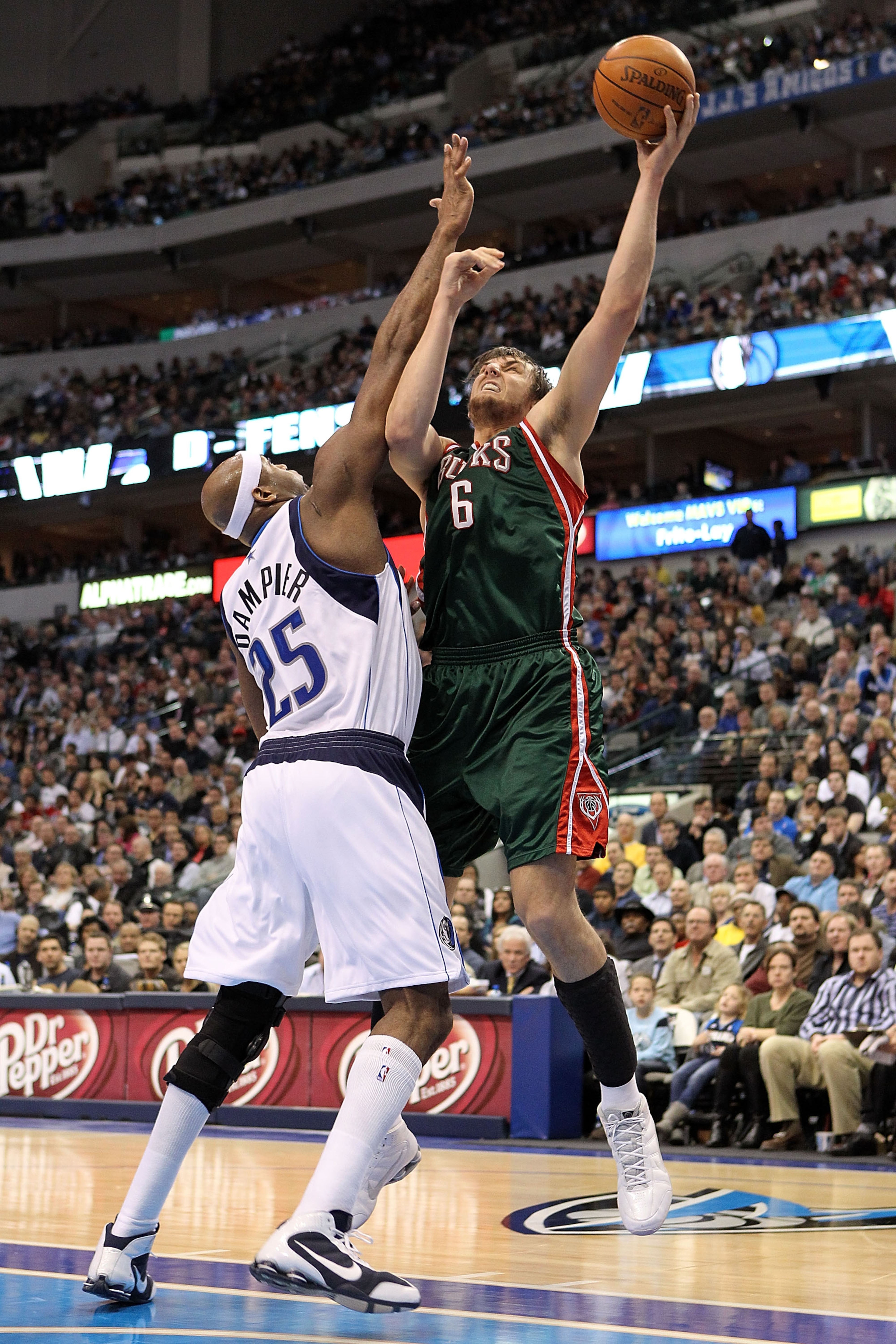 DALLAS - JANUARY 26:  Center Andrew Bogut #6 of the Milwaukee Bucks takes a shot against Erick Dampier #25 of the Dallas Mavericks on January 26, 2010 at American Airlines Center in Dallas, Texas.  NOTE TO USER: User expressly acknowledges and agrees that