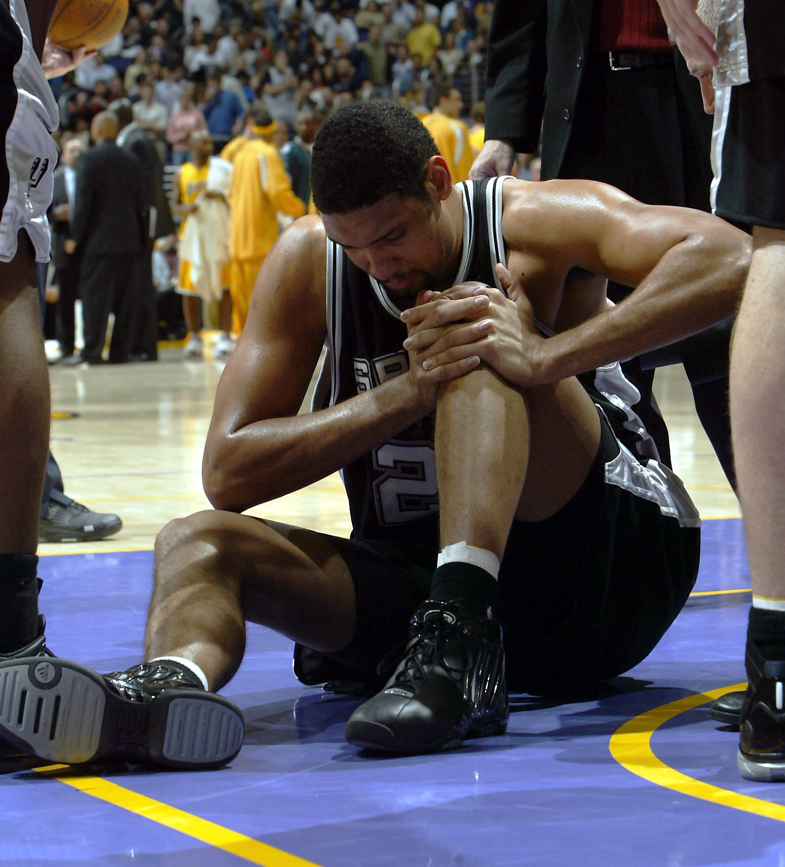 LOS ANGELES - FEBRUARY 3:  Tim Duncan #21 of the San Antonio Spurs holds his knee after hurting it in a fall during the game against the Los Angeles Lakers on February 3, 2005 at Staples Center in Los Angeles, California.  NOTE TO USER: User expressly ack