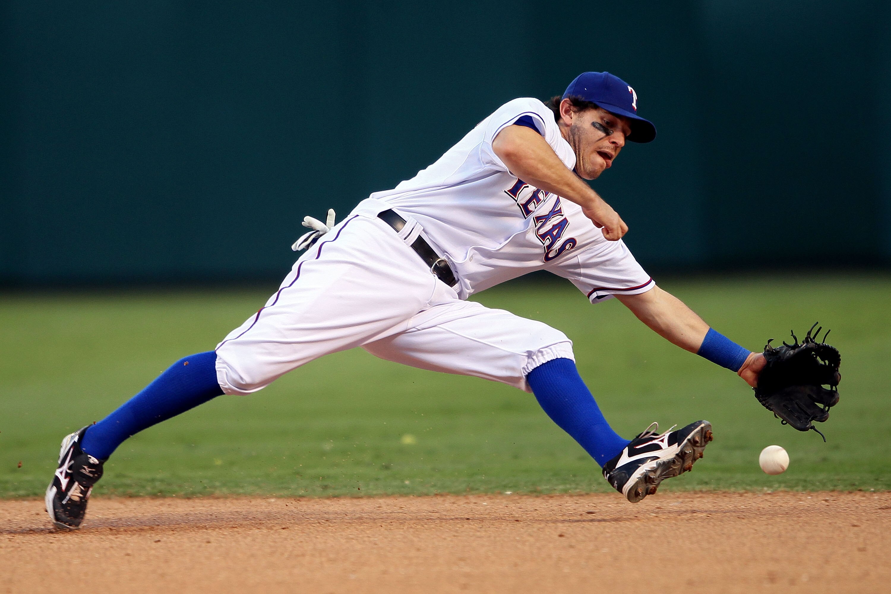 ARLINGTON, TX - OCTOBER 16:  Ian Kinsler #5 of the Texas Rangers fields a ground ball hit by Lance Berkman #17 of the New York Yankees in Game Two of the ALCS during the 2010 MLB Playoffs at Rangers Ballpark in Arlington on October 16, 2010 in Arlington,