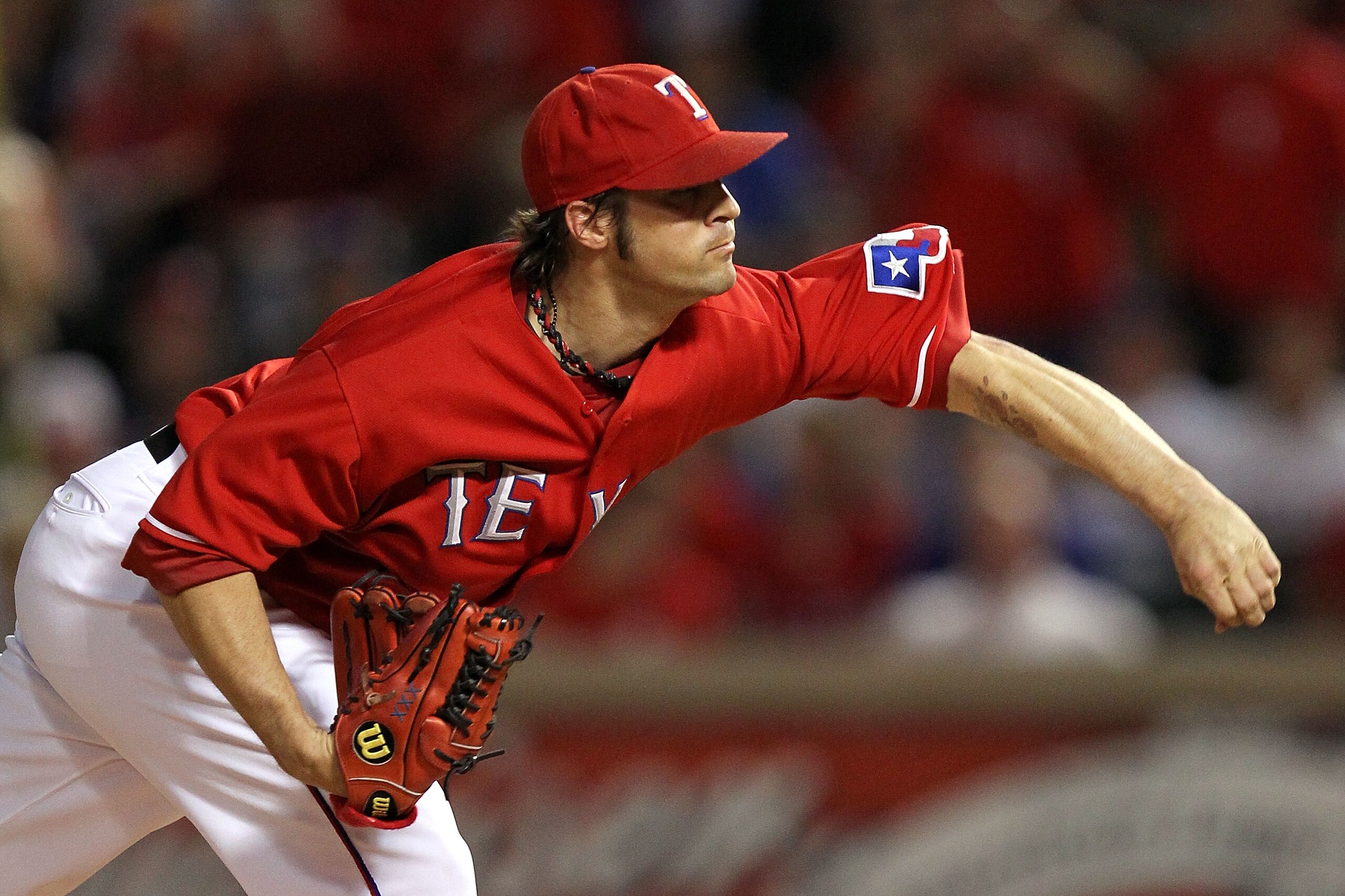 ARLINGTON, TX - OCTOBER 15:  Starting pitcher C.J. Wilson #36 of the Texas Rangers pitches against the New York Yankees in Game One of the ALCS during the 2010 MLB Playoffs at Rangers Ballpark in Arlington on October 15, 2010 in Arlington, Texas. The Yank