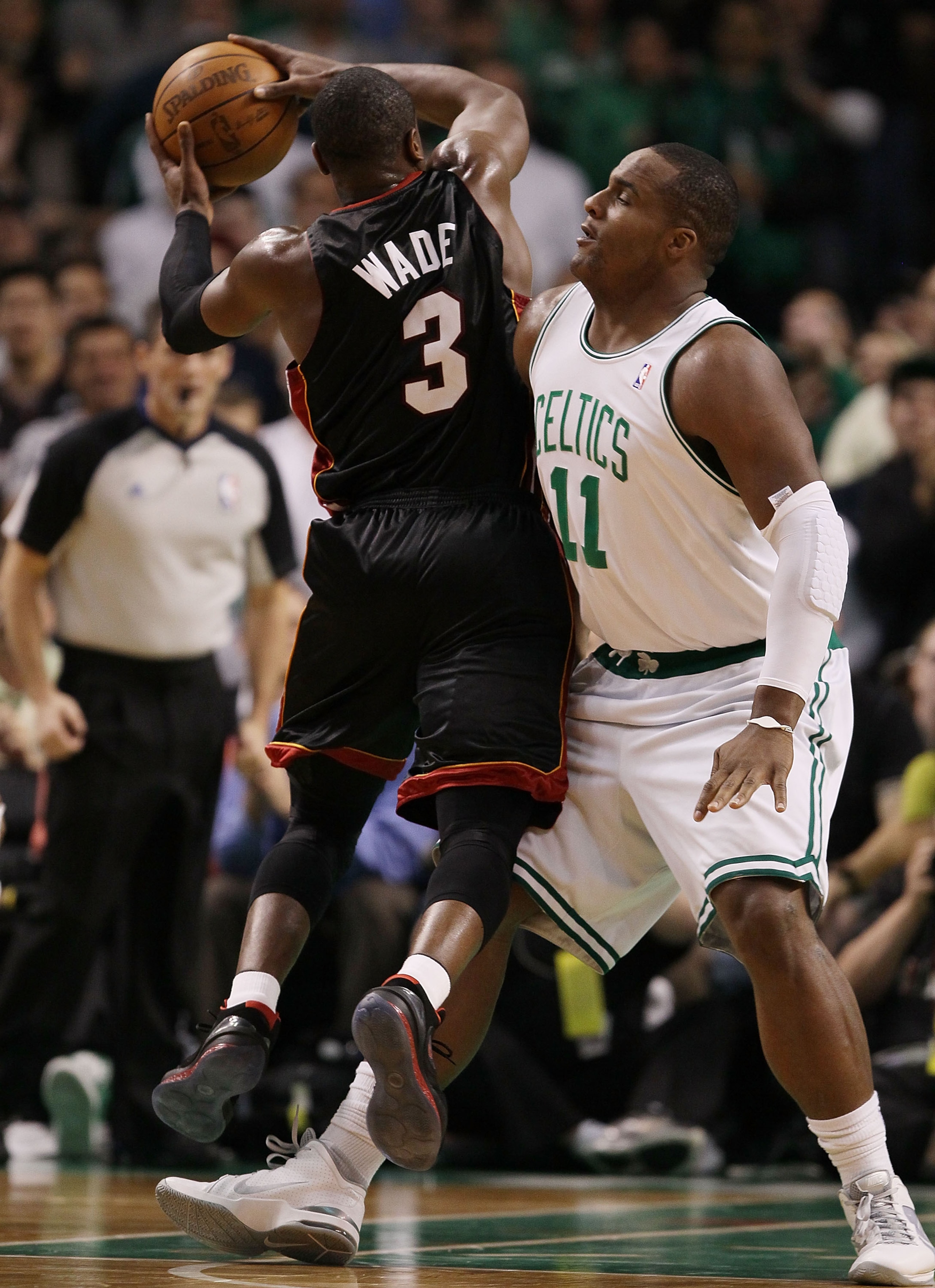 BOSTON - APRIL 27: Glen Davis #11 of the Boston Celtics tries to stop Dwyane Wade #3 of the Miami Heat from scoring during Game Five of the Eastern Conference Quarterfinals of the 2010 NBA playoffs at the TD Garden on April 27, 2010 in Boston, Massachuse BOSTON - APRIL 27: Glen Davis #11 of the Boston Celtics tries to stop Dwyane Wade #3 of the Miami Heat from scoring during Game Five of the Eastern Conference Quarterfinals of the 2010 NBA playoffs at the TD Garden on April 27, 2010 in Boston, Massachuse