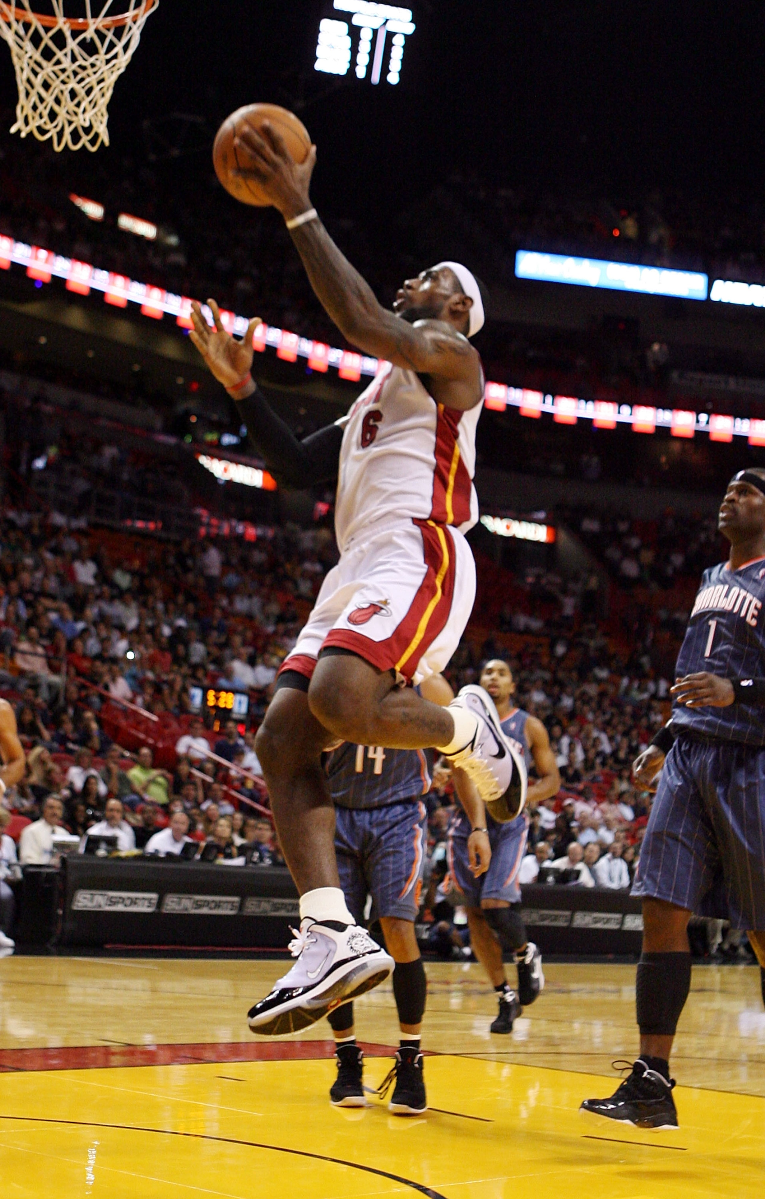 MIAMI - OCTOBER 18:  Forward LeBron James #6 of the Miami Heat shoots over guard D.J. Augustin #14 of the Charlotte Bobcats on October 18, 2010 in Miami, Florida.  (Photo by Marc Serota/Getty Images)