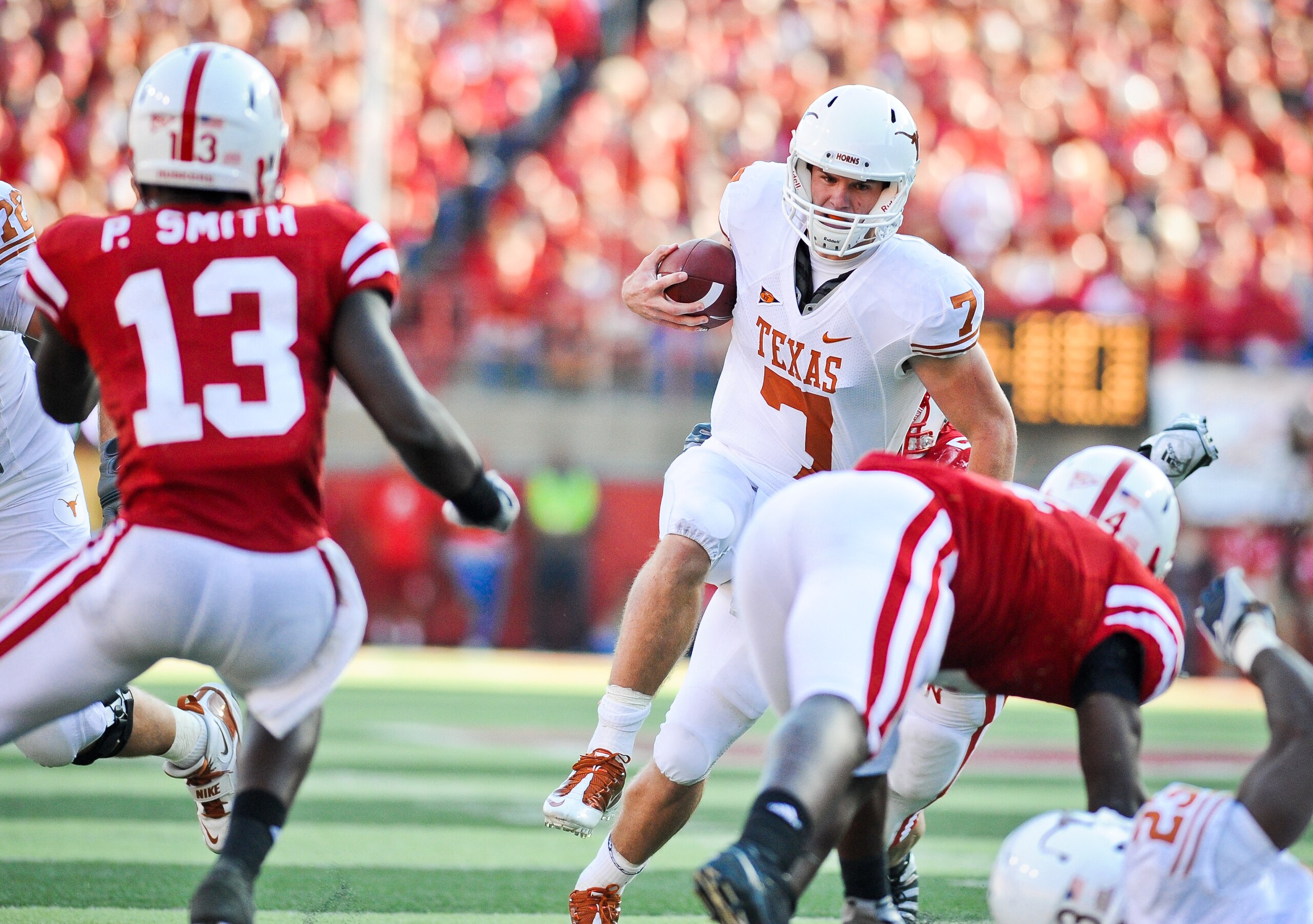 LINCOLN, NE - OCTOBER 16: Quarterback Garrett Gilbert #7 of the Texas Longhorns runs through the Nebraska Cornhusker Defense during their game at Memorial Stadium on October 16, 2010 in Lincoln, Nebraska. Texas Defeated Nebraska 20-13. (Photo by Eric Fran