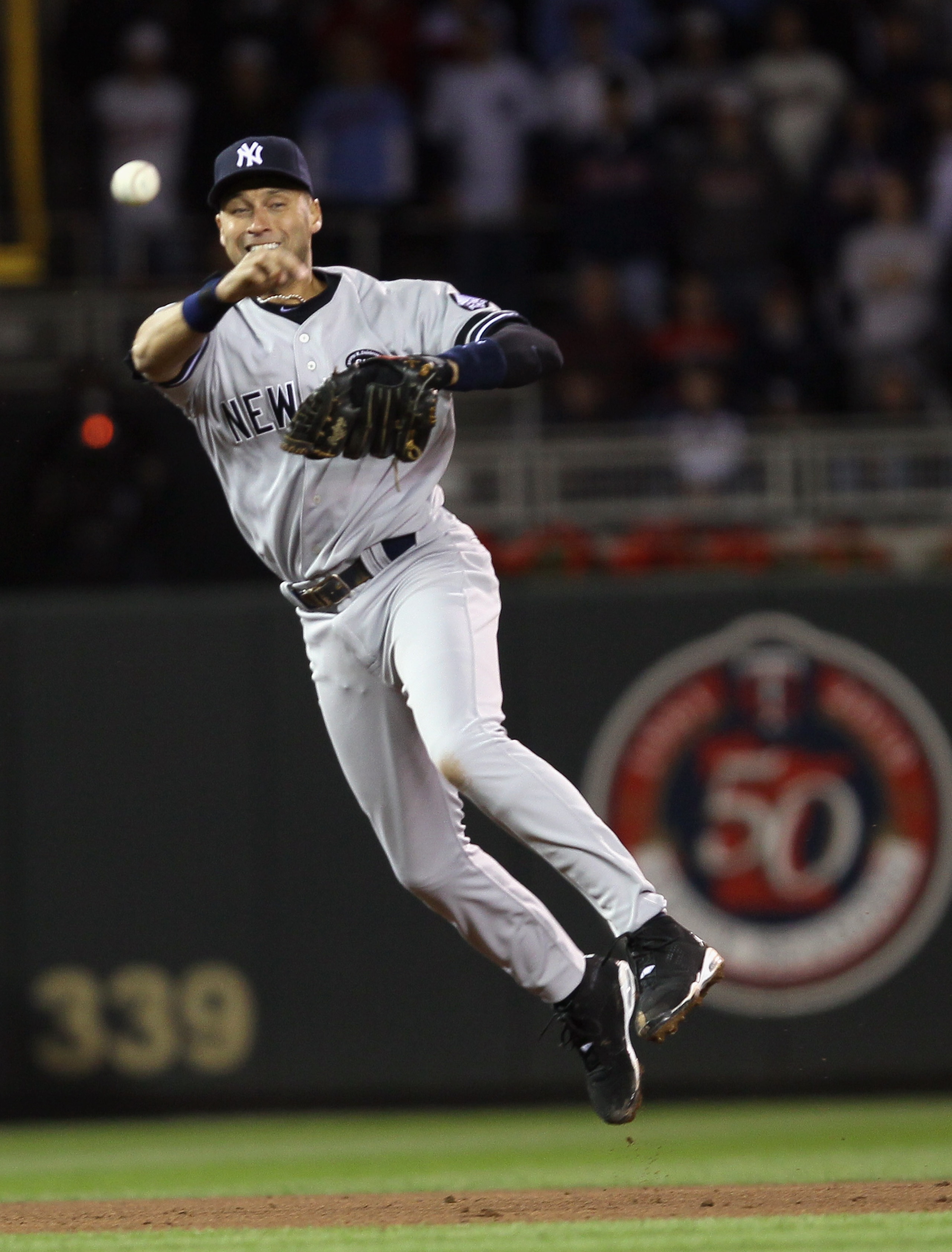 MINNEAPOLIS - OCTOBER 06:  Derek Jeter #2 of the New York Yankees sends the ball to first for the out against the Minnesota Twins during game one of the ALDS on October 6, 2010 at Target Field in Minneapolis, Minnesota. The Yankees defeated the Twins 6-4.
