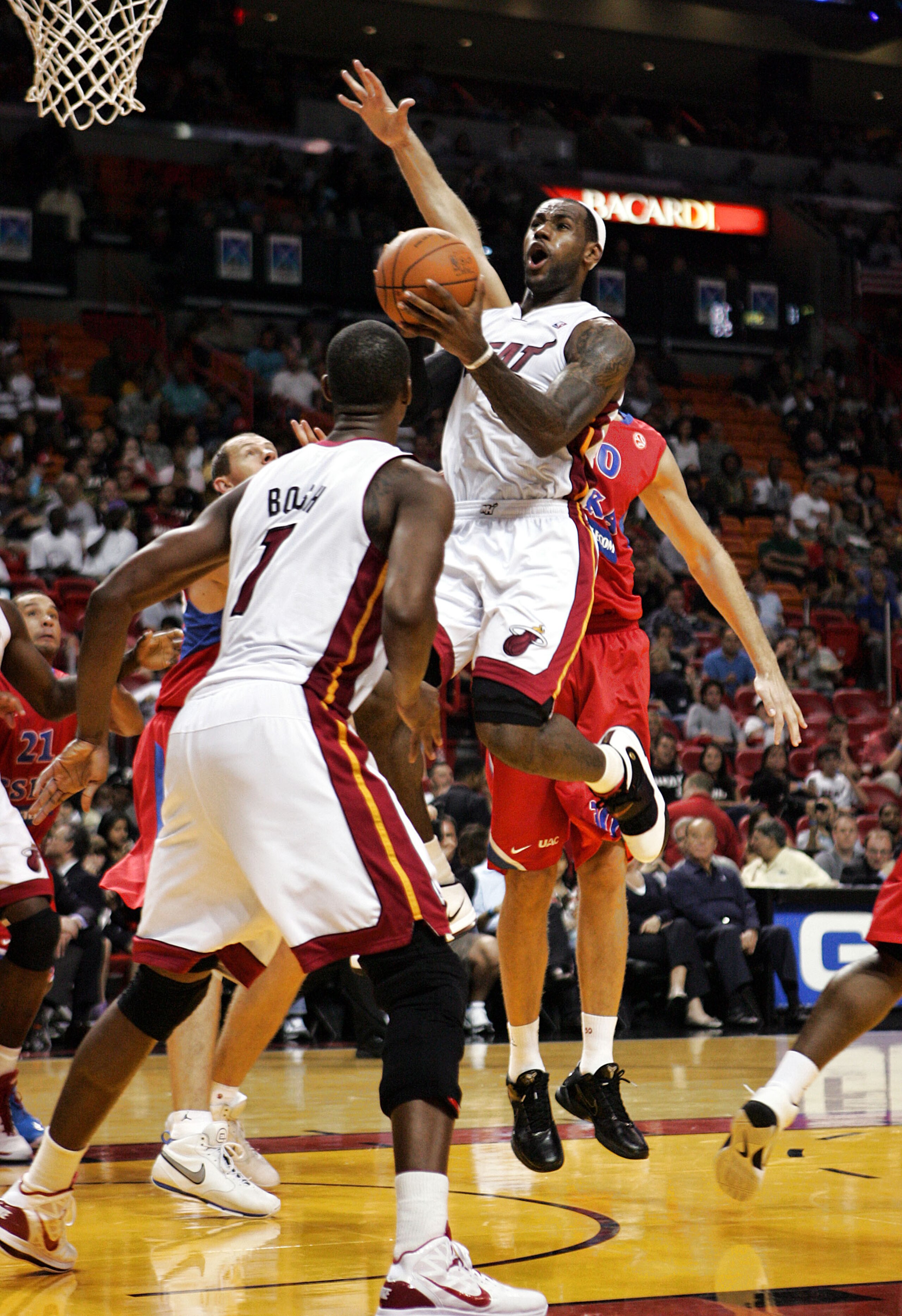 MIAMI - OCTOBER 12:  Forward LeBron James #6 scors and Chris Bosh #1 looks on of the Miami Heat CSKA Moskow on October 12, 2010 in Miami, Florida.  NOTE TO USER: User expressly acknowledges and agrees that, by downloading and or using this photograph, Use