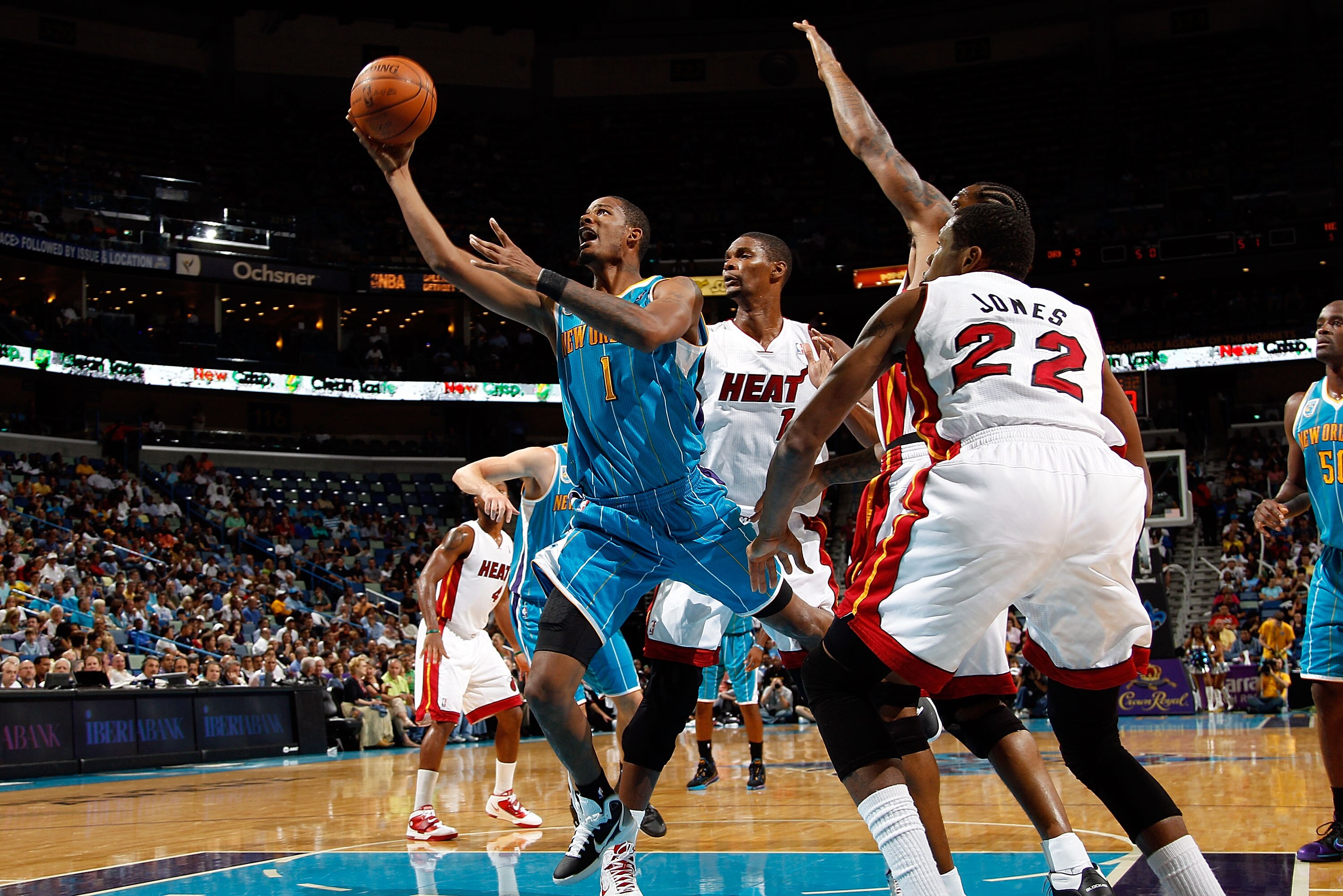 NEW ORLEANS - OCTOBER 13:  Trevor Ariza #1 of the New Orleans Hornets shoots the ball over Chris Bosh #1 of the Miami Heat at the New Orleans Arena on October 13, 2010 in New Orleans, Louisiana. NOTE TO USER: User expressly acknowledges and agrees that, b