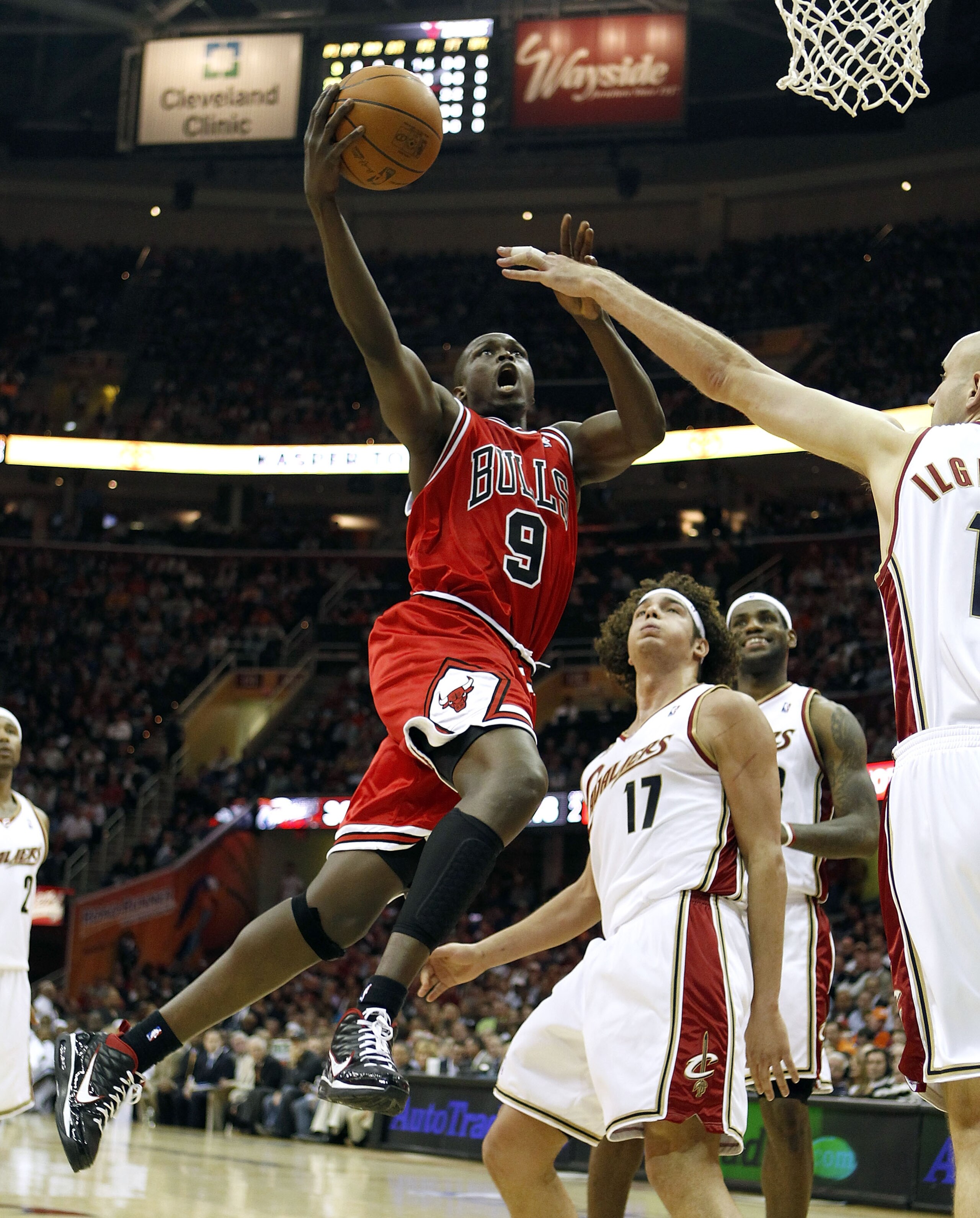CLEVELAND - APRIL 19: Luol Deng #9 of the Chicago Bulls gets a shot off next to Anderson Varejao #17 and Zydrunas Ilgauskas #11 of the Cleveland Cavaliers in Game Two of the Eastern Conference Quarterfinals during the 2010 NBA Playoffs at Quicken Loans Ar