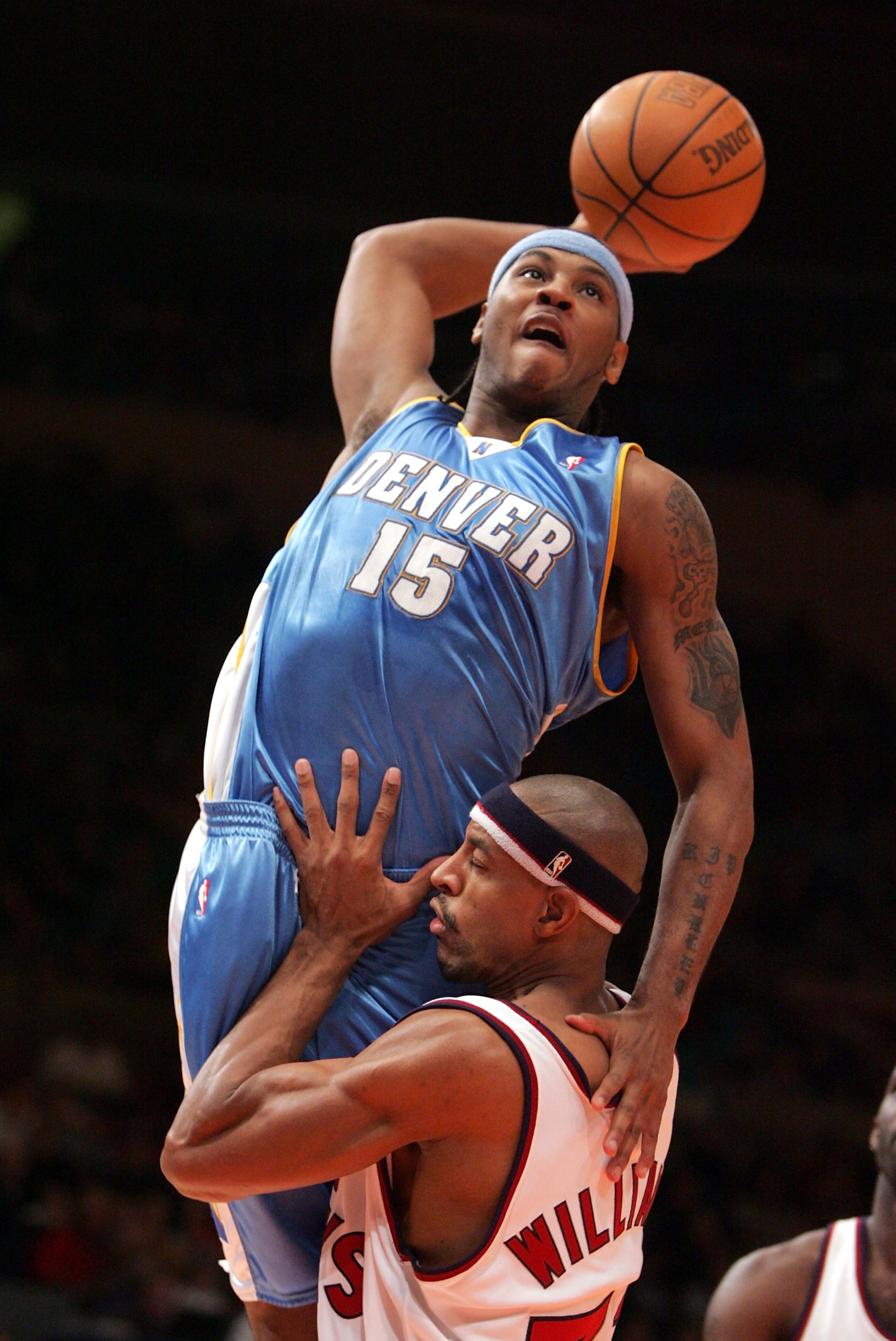 NEW YORK - DECEMBER 12:  Carmelo Anthony #15 of the Denver Nuggets attempts a dunk over Jerome Williams #31 of the New York Knicks on December 12, 2004 at Madison Square Garden in New York City.  NOTE TO USER: User expressly acknowledges and agrees that,