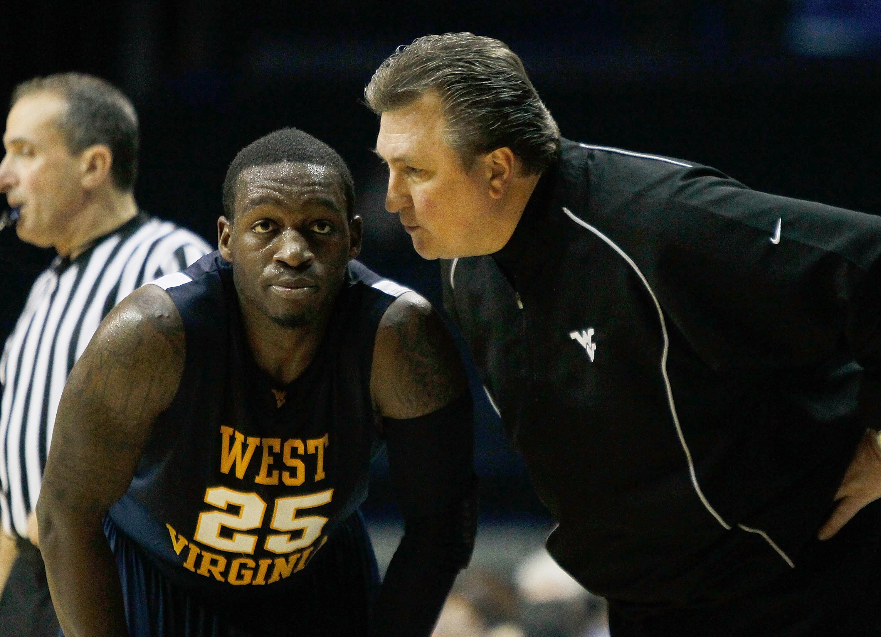 ROSEMONT, IL - JANUARY 26: Head coach Bob Huggins of the West Virginia Mountaineers talks to Darryl Bryant #25 during a game against the DePaul Blue Demons at the Allstate Arena on January 26, 2010 in Rosemont, Illinois. West Virginia defeated DePaul 62-4