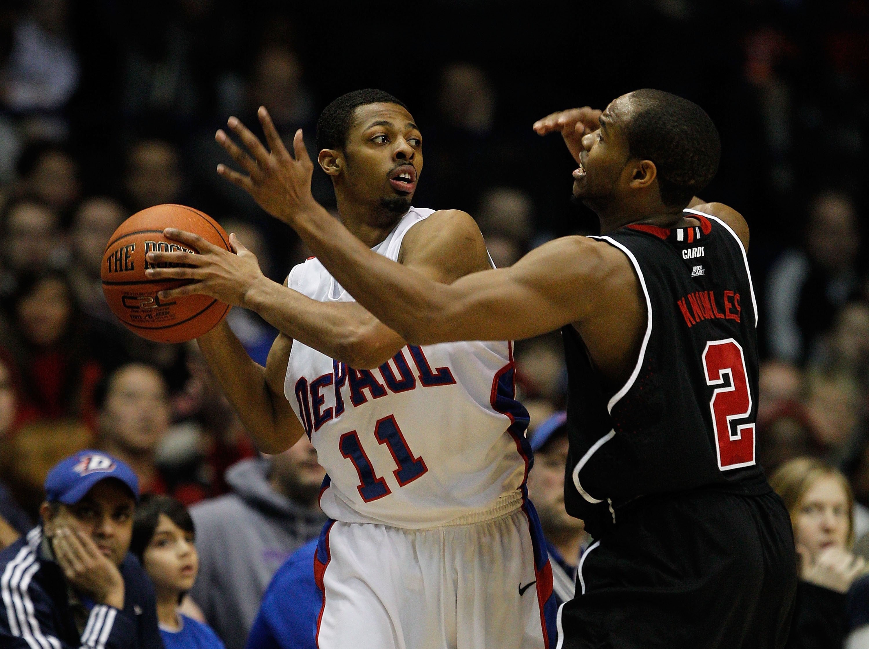 ROSEMONT, IL - FEBRUARY 20: Jeremiah Kelly #11 of the DePaul Blue Demons tries to pass under pressure from Preston Knowles #2 of the Louisville Cardinals at the Allstate Arena on February 20, 2010 in Rosemont, Illinois. Louisville defeated DePaul 68-59. (