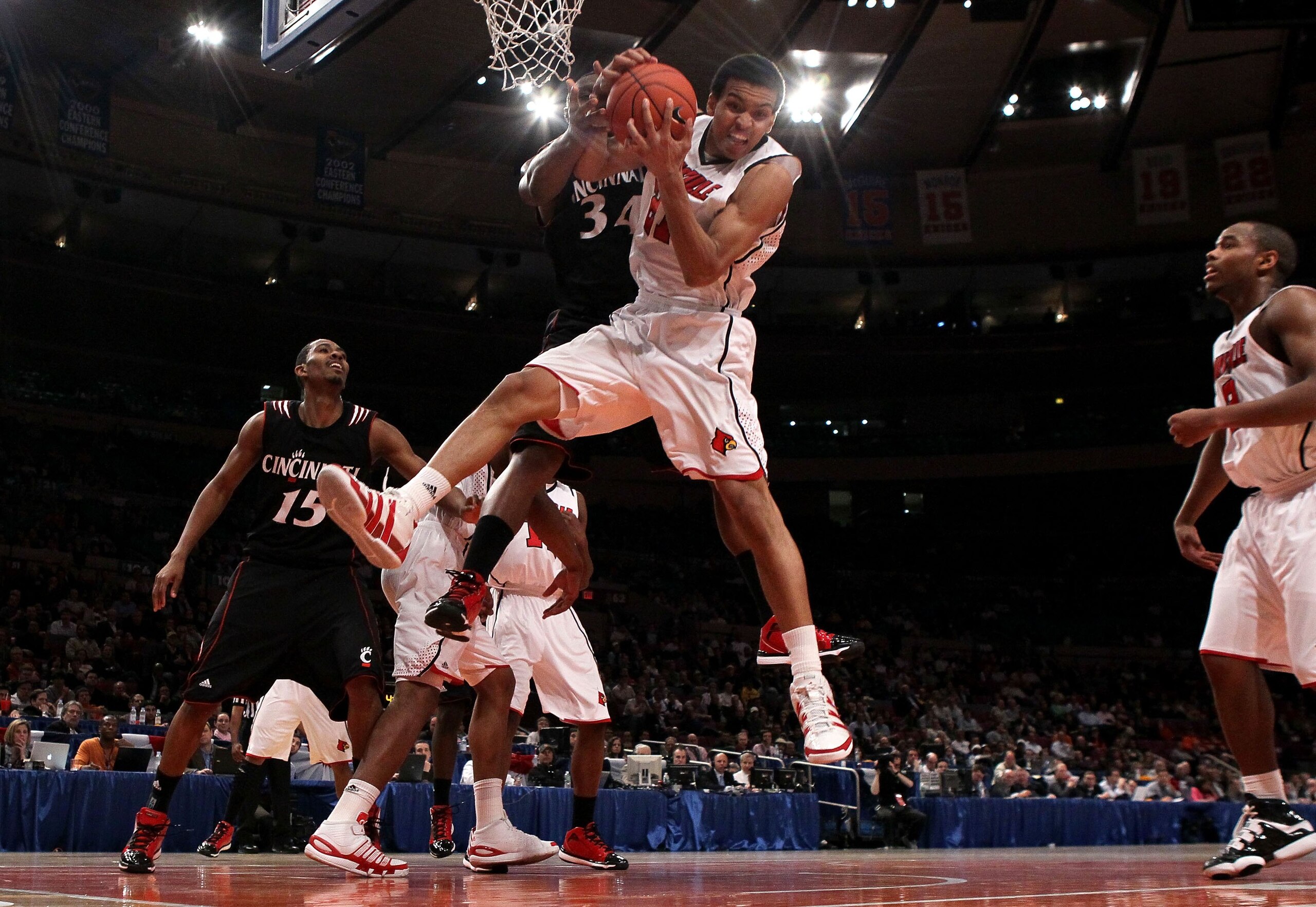 NEW YORK - MARCH 10: Jared Swopshire #21 of the Louisville Cardinals pulls down a rebound against the Cincinnati Bearcats during the second round of 2010 NCAA Big East Tournament at Madison Square Garden on March 10, 2010 in New York City.  (Photo by Jim