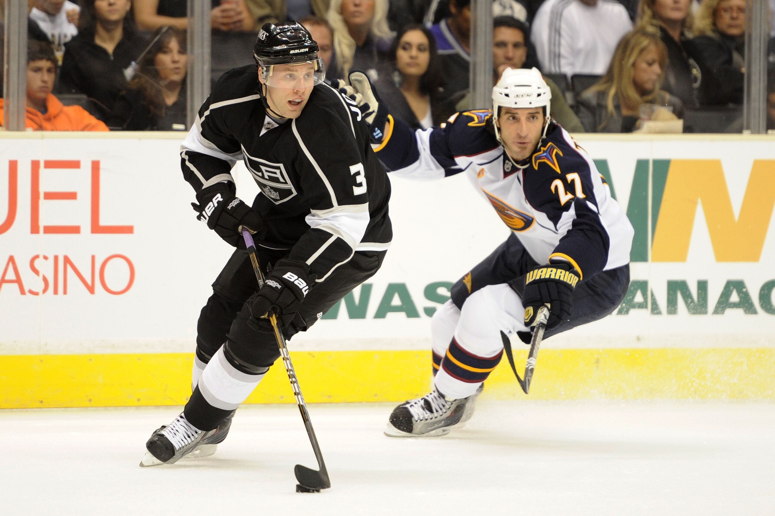LOS ANGELES, CA - OCTOBER 12:  Jack Johnson #3 of the Los Angeles Kings controls the puck against Chris Thorburn #27 of the Atlanta Thrashers during their game at Staples Center on October 12, 2010 in Los Angeles, California.  (Photo by Harry How/Getty Im