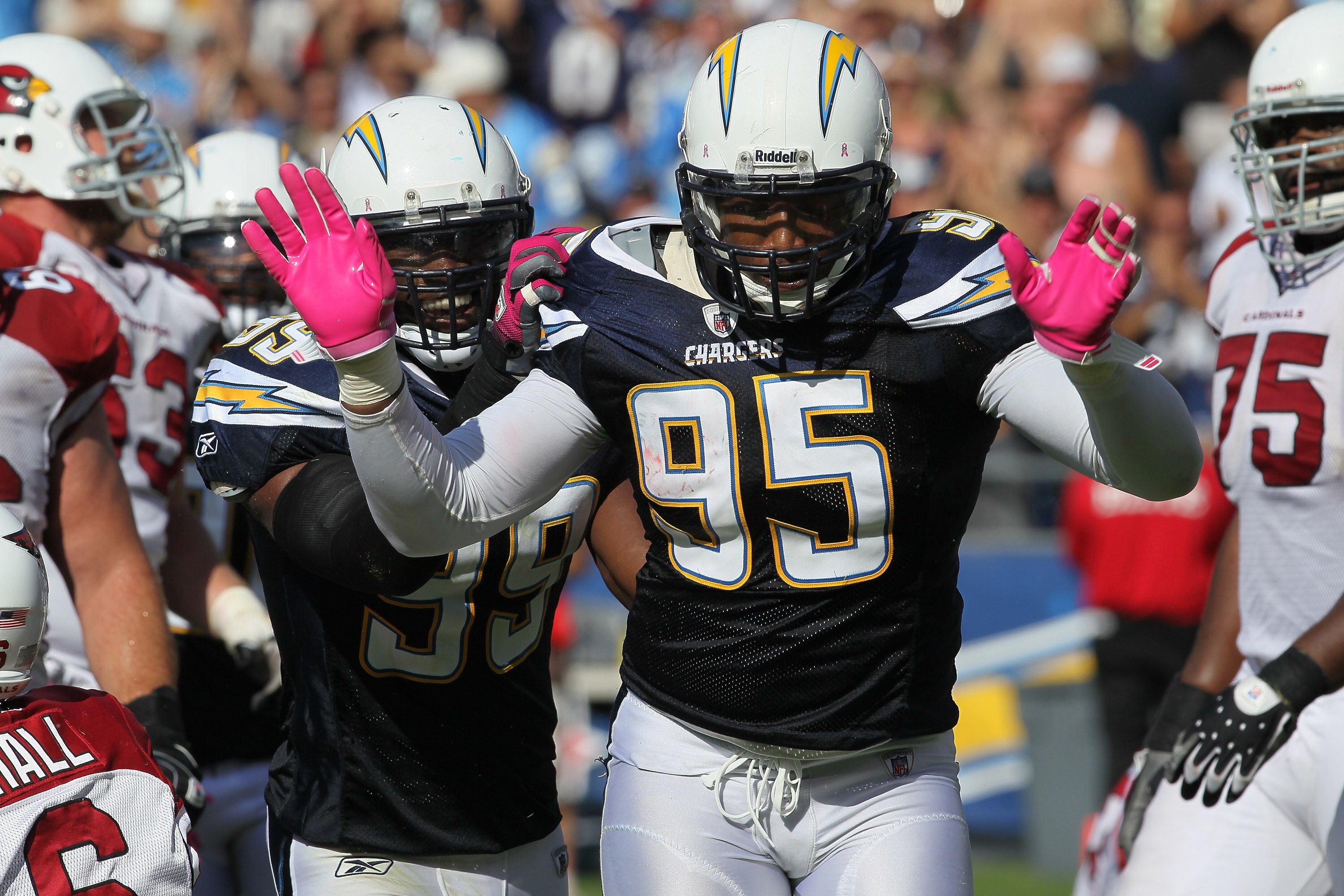 SAN DIEGO - OCTOBER 03:  Linebackers Shaun Phillips #95 and Kevin Burnett #99 of the San Diego Chargers celebrate a Phillips sack against the Arizona Cardinals at Qualcomm Stadium on October 3, 2010 in San Diego, California.   The Chargers won 41-10.  (Ph