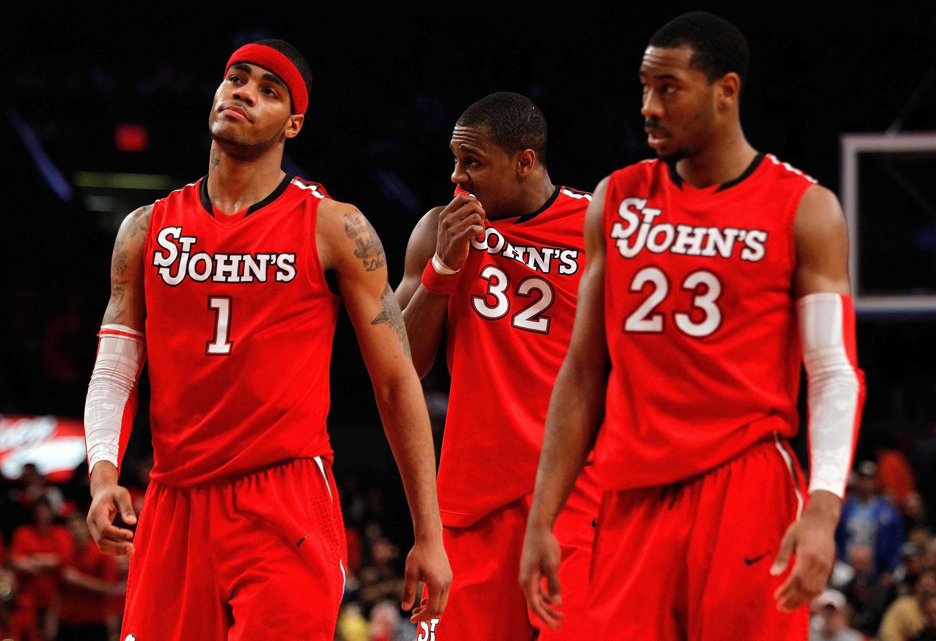 NEW YORK - MARCH 10:  D.J. Kennedy #1, Justin Brownlee #32 and Paris Horne #23 of the St. John's Red Storm look on towards the end of their game against the Marquette Golden Eagles during the second round of 2010 NCAA Big East Tournament at Madison Square