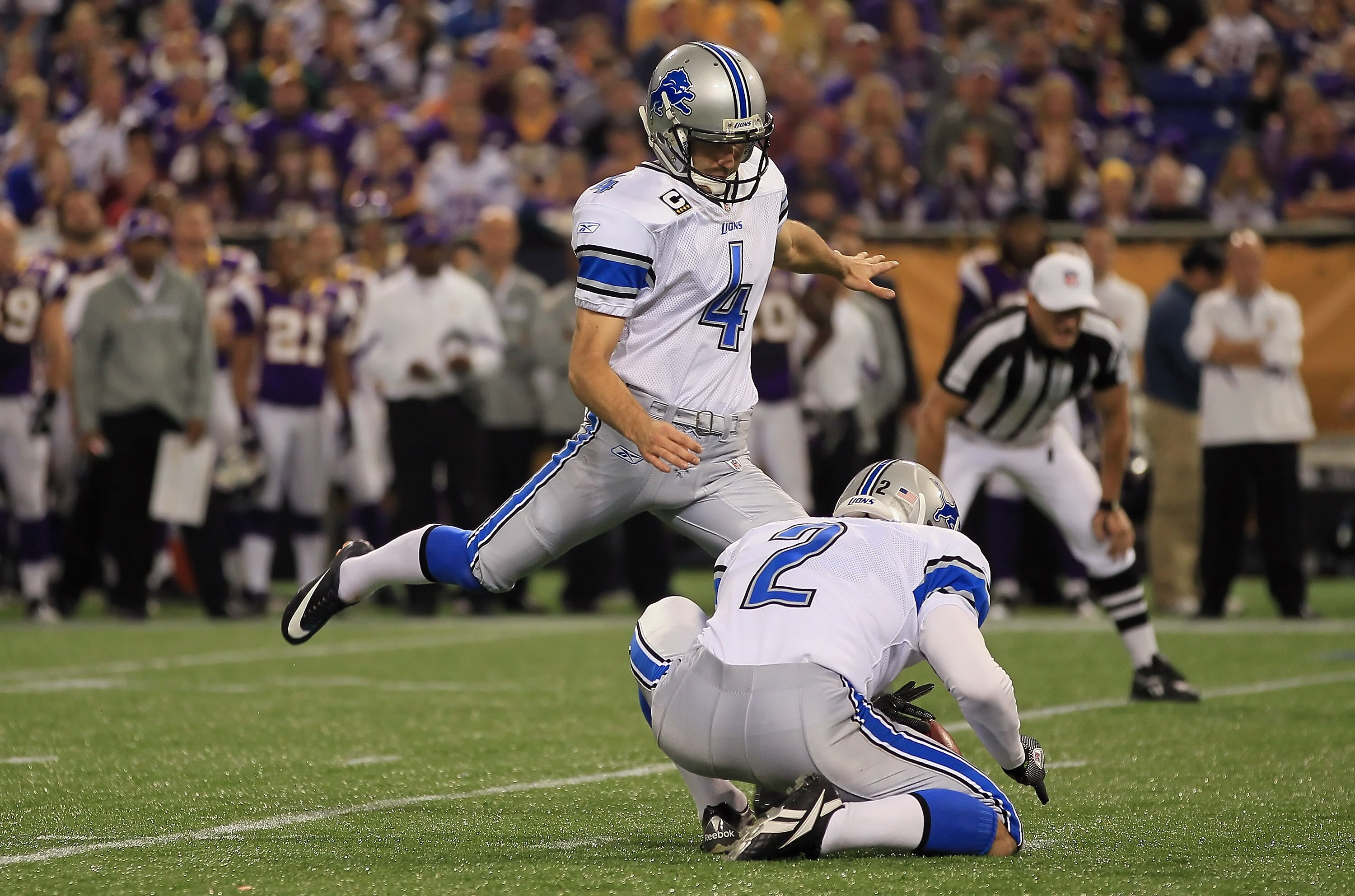 MINNEAPOLIS - SEPTEMBER 26:  Kicker Jason Hanson #4 of the Detroit Lions kicks as place kicker Nick Harris #2 holds against the Minnesota Vikings at Mall of America Field on September 26, 2010 in Minneapolis, Minnesota.  (Photo by Jeff Gross/Getty Images)