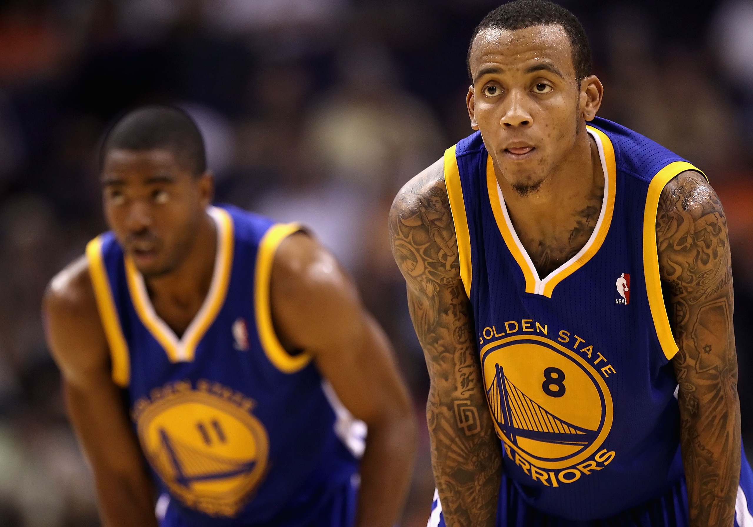 PHOENIX - OCTOBER 19:  Monta Ellis #8 (R) and Aaron Miles #11 of the Golden State Warriors await a free throw shot against the Phoenix Suns during the preseason NBA game at US Airways Center on October 19, 2010 in Phoenix, Arizona. NOTE TO USER: User expr