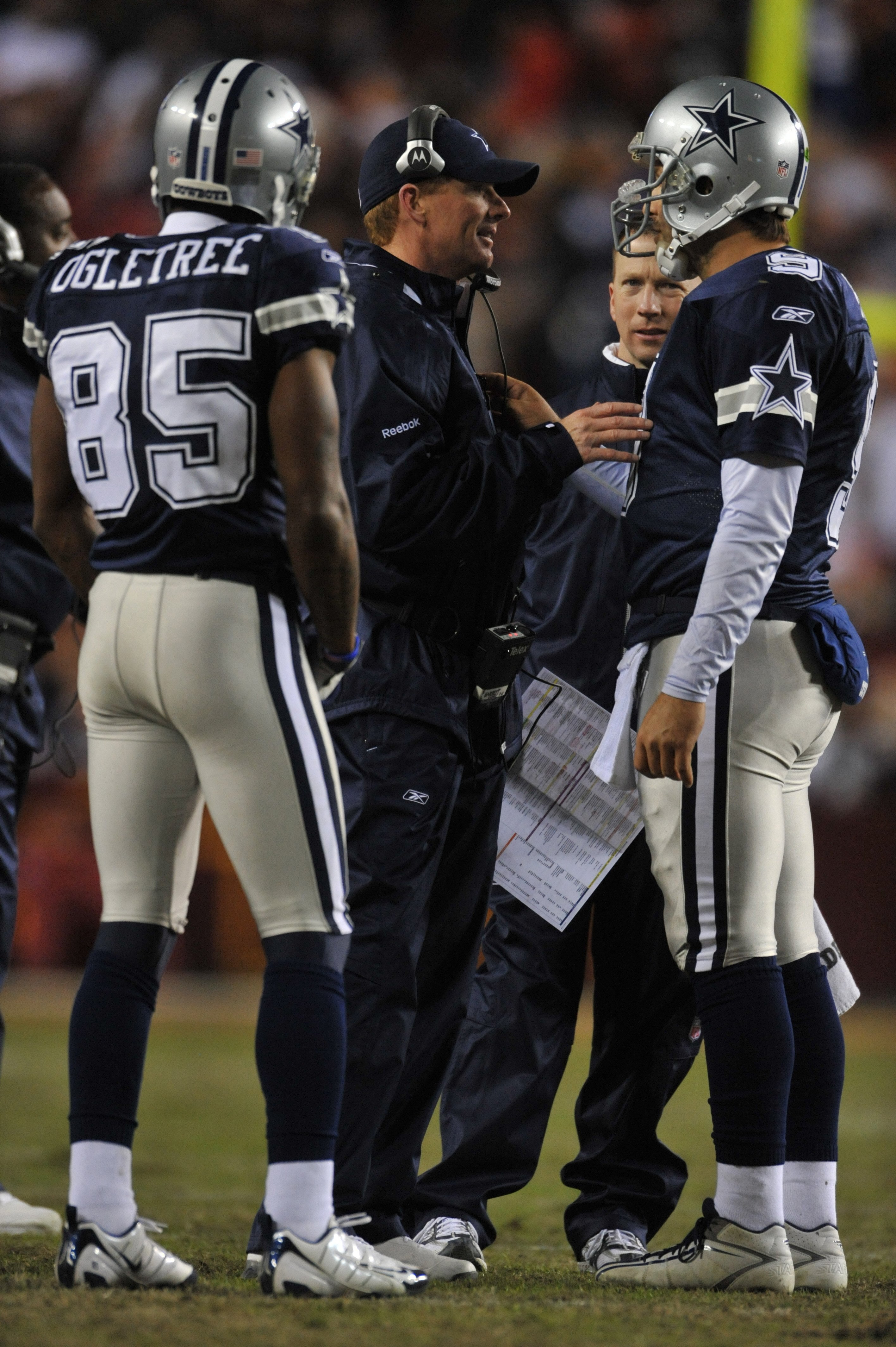 LANDOVER, MD - DECEMBER 27:  Assistant head coach Jason Garrett of the Dallas Cowboys speaks with Tony Romo #9 during the game against the Washington Redskins at FedExField on December 27, 2009 in Landover, Maryland. The Cowboys defeated the Redskins 17-0