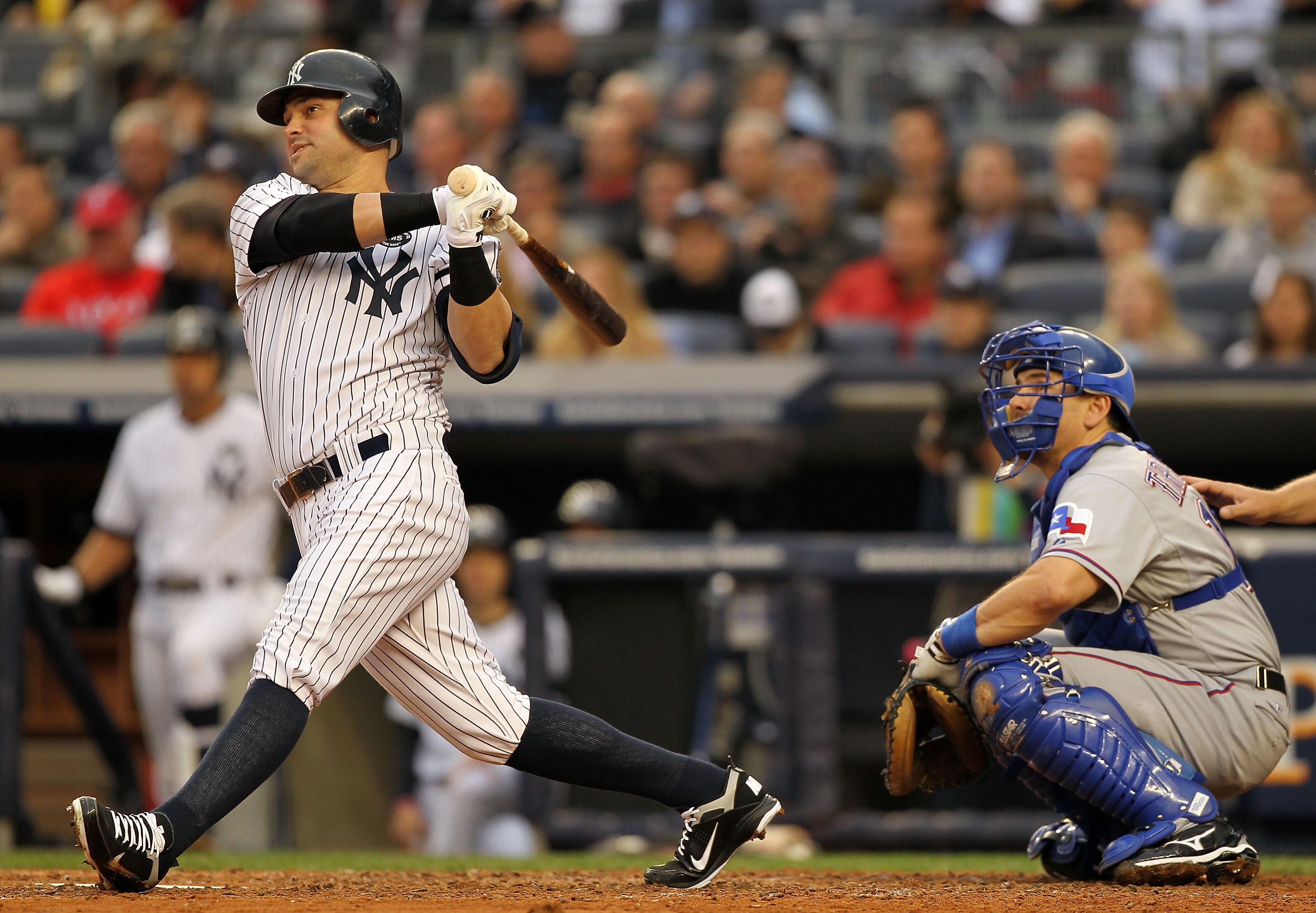 NEW YORK - OCTOBER 20:  Nick Swisher #33 of the New York Yankees hits a solo home run in the bottom of the third inning against the Texas Rangers in Game Five of the ALCS during the 2010 MLB Playoffs at Yankee Stadium on October 20, 2010 in the Bronx boro