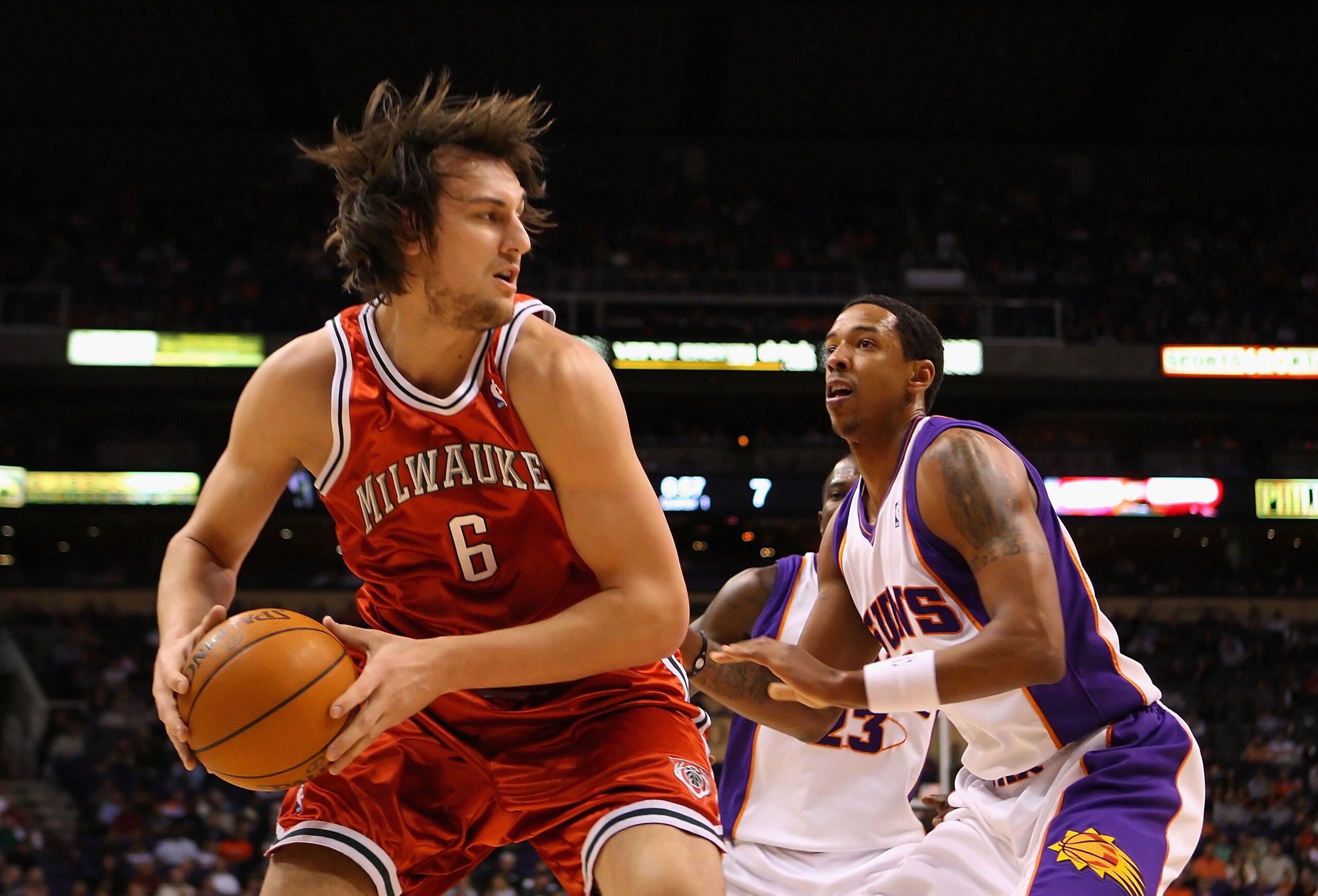 PHOENIX - JANUARY 11:  Andrew Bogut #6 of the Milwaukee Bucks handles the ball under pressure from Channing Frye #8 of the Phoenix Suns during the NBA game at US Airways Center on January 11, 2010 in Phoenix, Arizona. The Suns defeated the Rockets 118-110