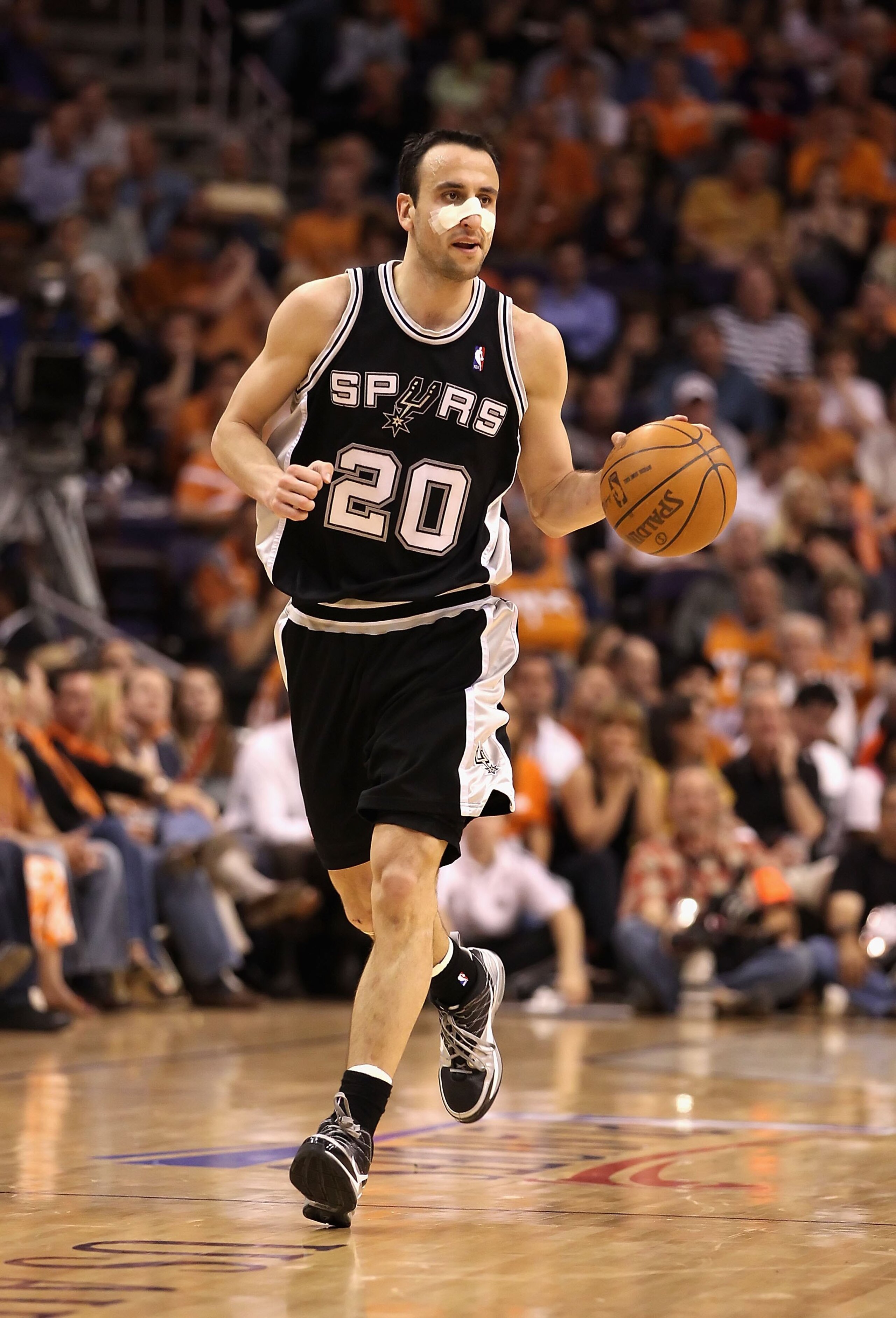 PHOENIX - MAY 05:  Manu Ginobili #20 of the San Antonio Spurs handles the ball during Game Two of the Western Conference Semifinals of the 2010 NBA Playoffs against the Phoenix Suns at US Airways Center on May 5, 2010 in Phoenix, Arizona. The team is wear