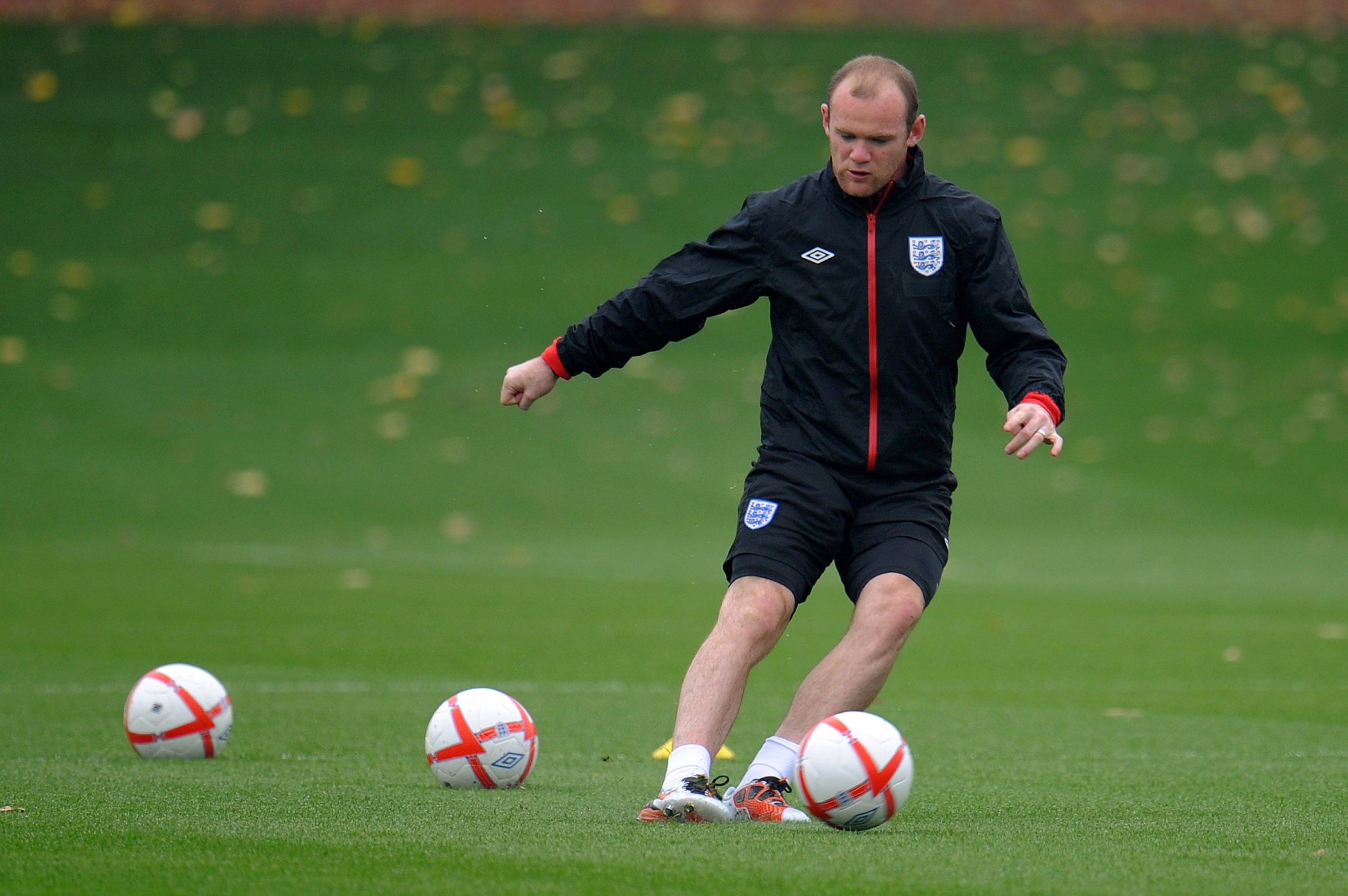 ST ALBANS, ENGLAND - OCTOBER 08:  Wayne Rooney passes a ball during the England training session at London Colney on October 8, 2010 in St Albans, England.  (Photo by Michael Regan/Getty Images)