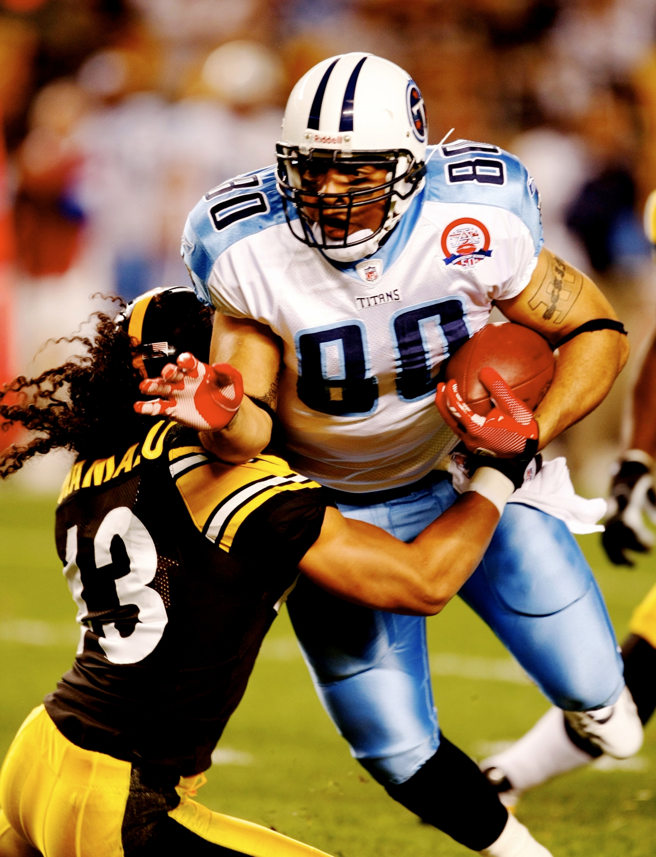 PITTSBURGH - SEPTEMBER 10:  Troy Polamalu #43 of the Pittsburgh Steelers tries to tackle Bo Scaife #80 of the Tennessee Titans during the game at Heinz Field on September 10, 2009 in Pittsburgh, Pennsylvania. (Photo by Scott Boehm/Getty Images)