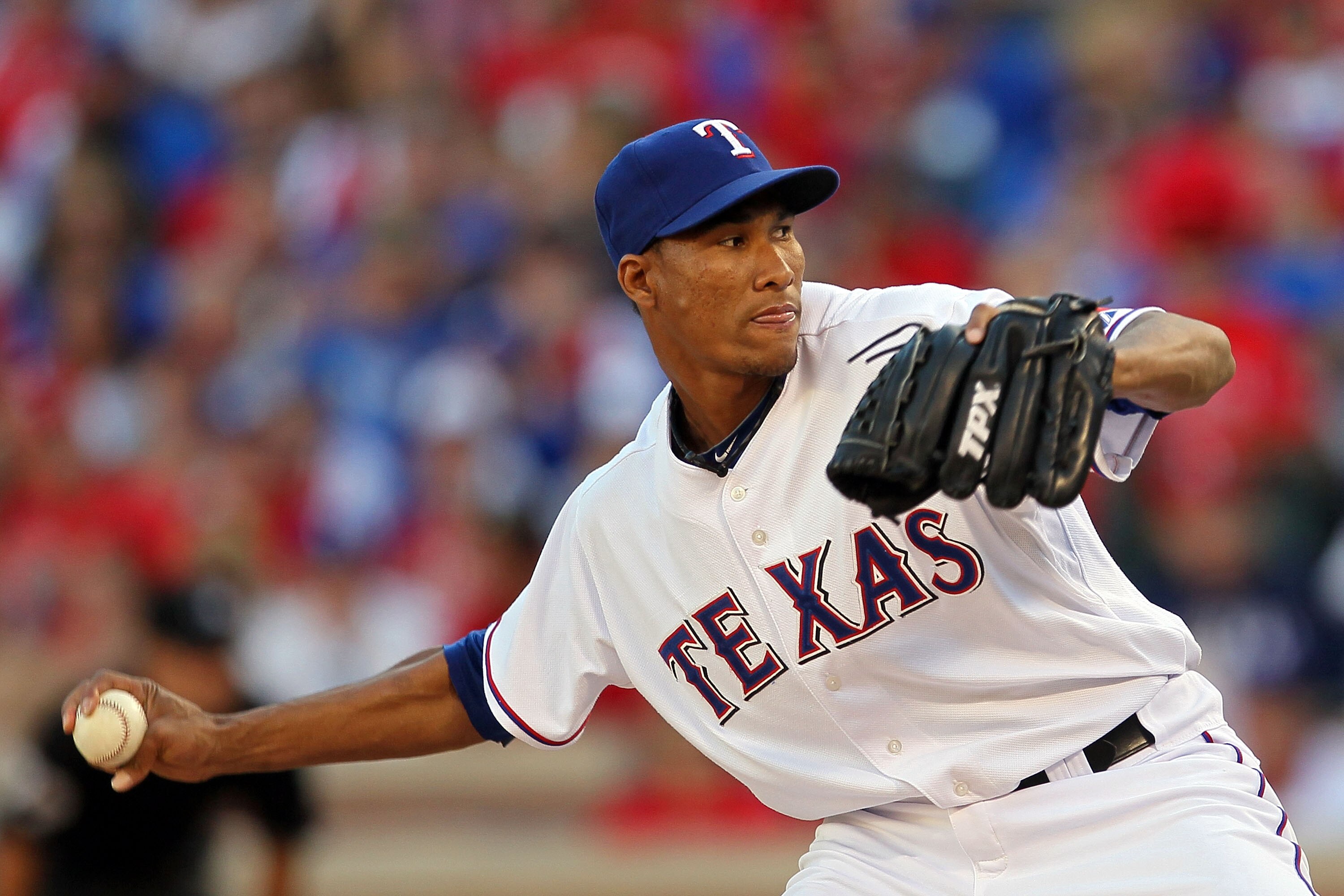 ARLINGTON, TX - OCTOBER 16:  Alexi Ogando #64 of the Texas Rangers pitches against the New York Yankees in Game Two of the ALCS during the 2010 MLB Playoffs at Rangers Ballpark in Arlington on October 16, 2010 in Arlington, Texas.  (Photo by Stephen Dunn/