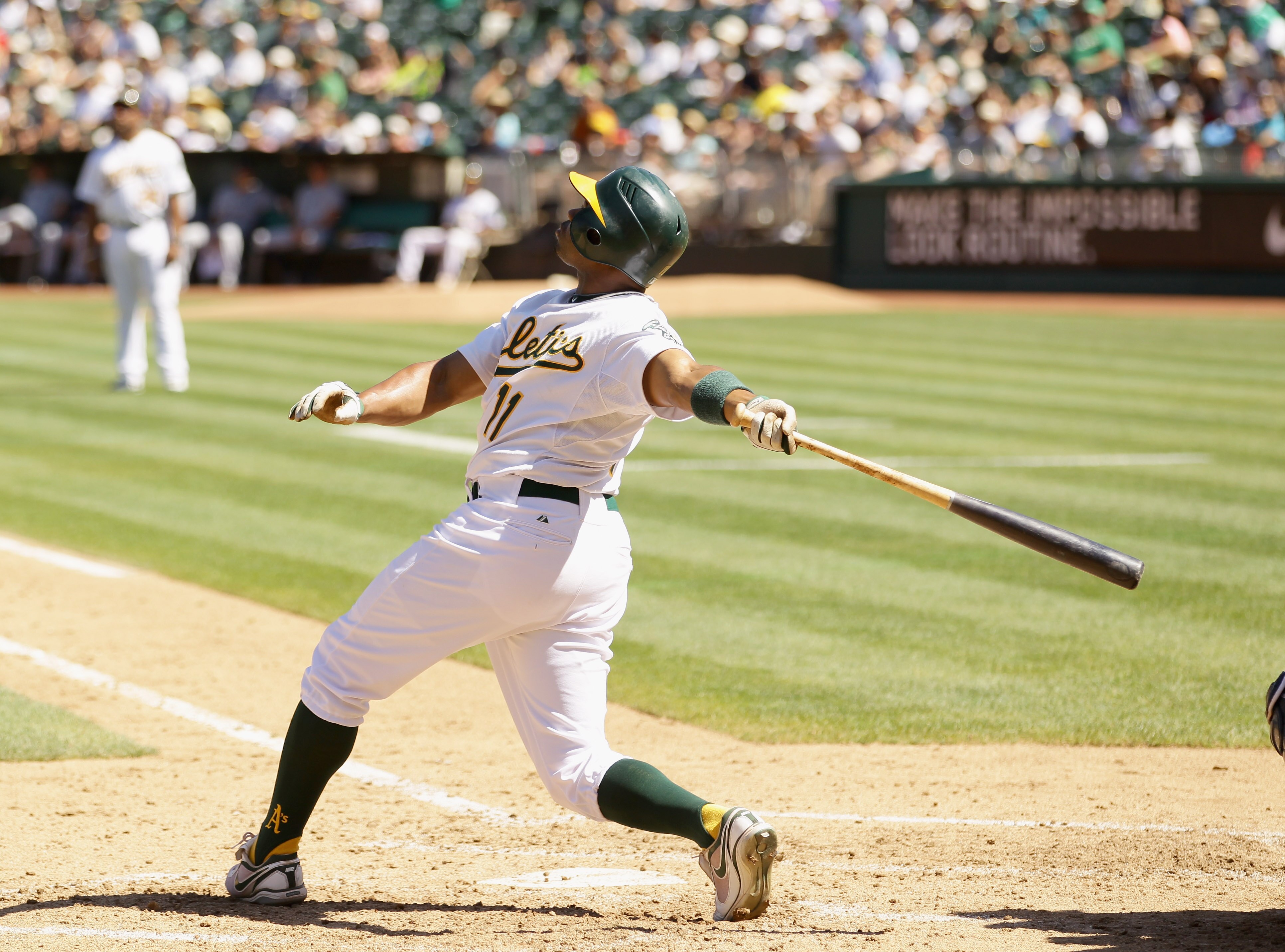 OAKLAND, CA - SEPTEMBER 06:  Rajai Davis #11 of the Oakland Athletics hits a sac fly that scored Jack Cust during their game against the Seattle Mariners at the Oakland-Alameda County Coliseum on September 6, 2010 in Oakland, California.  (Photo by Ezra S
