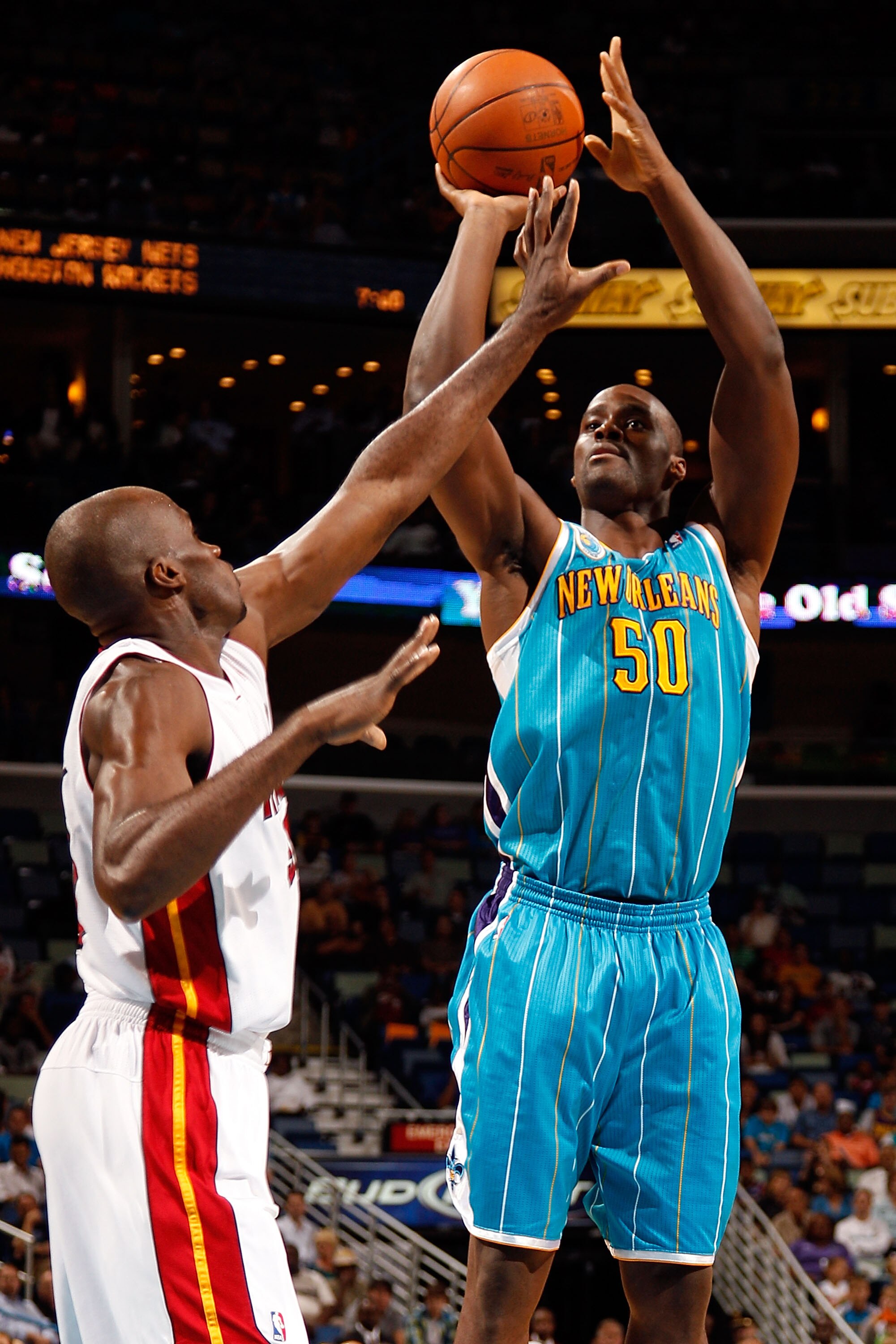 NEW ORLEANS - OCTOBER 13:  Emeka Okafor #50 of the New Orleans Hornets makes a shot over Joel Anthony #50 of the Miami Heat at the New Orleans Arena on October 13, 2010 in New Orleans, Louisiana. NOTE TO USER: User expressly acknowledges and agrees that,