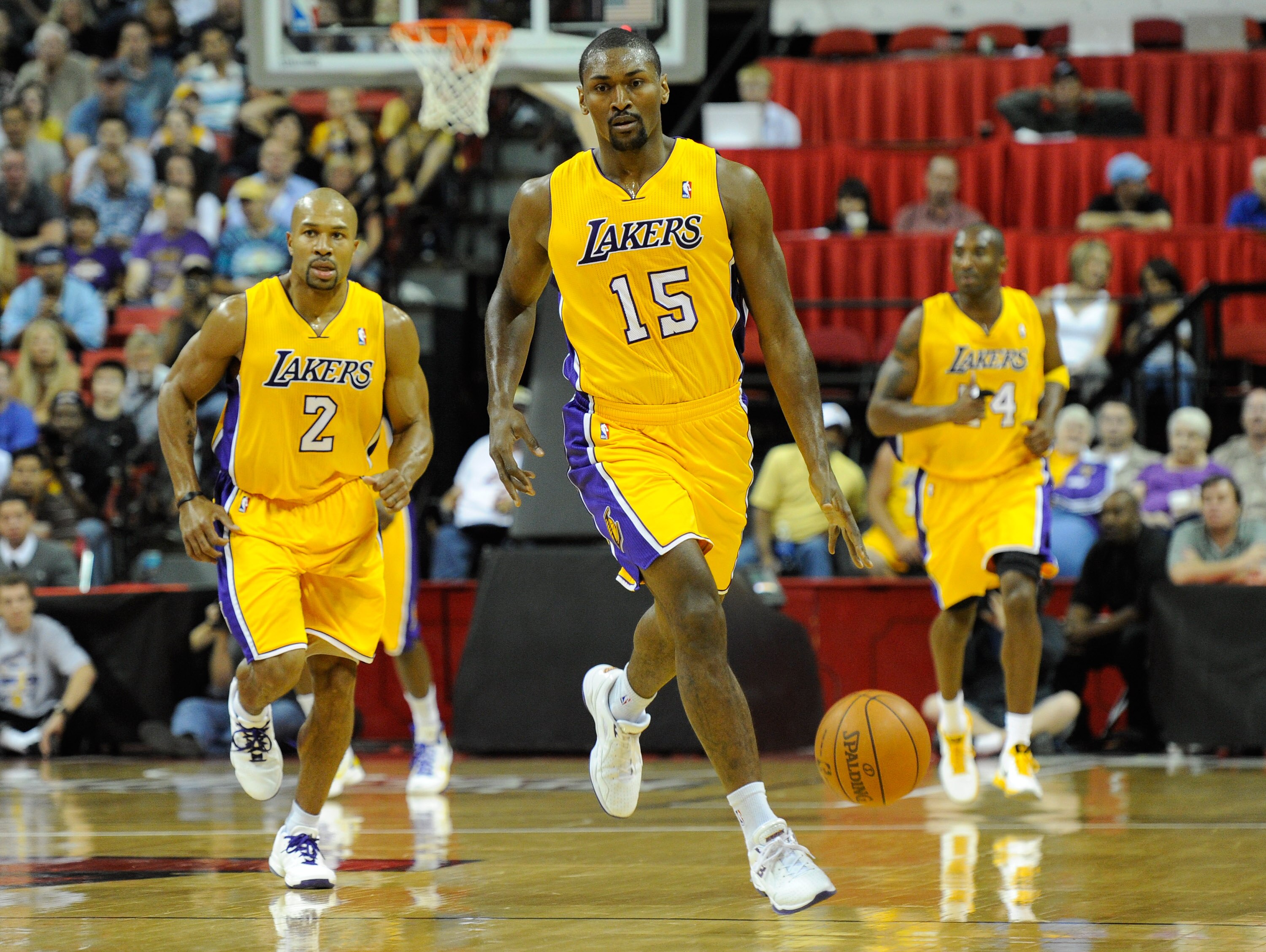 LAS VEGAS - OCTOBER 13:  Ron Artest #15 of the Los Angeles Lakers brings the ball up the court with teammates Derek Fisher #2 and Kobe Bryant #24 trailing during their preseason game against the Sacramento Kings at the Thomas & Mack Center October 13, 201