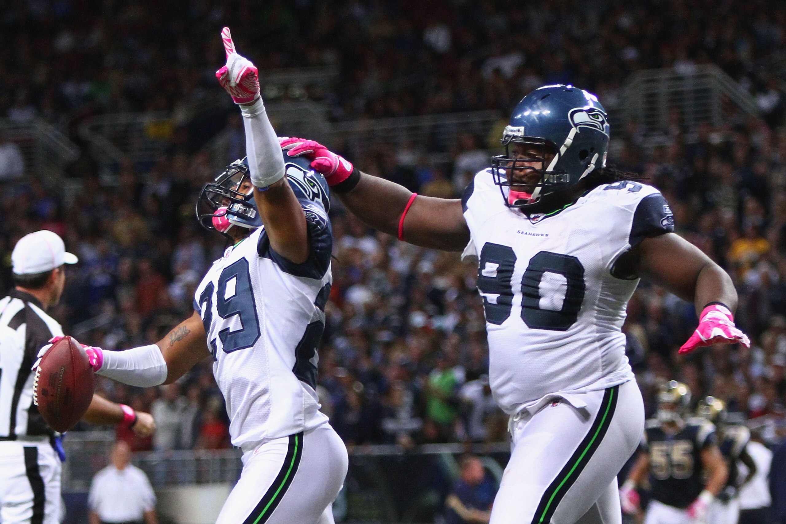 ST. LOUIS - OCTOBER 3: Earl Thomas #29 and Colin Cole #90 both of the Seattle Seahawks celebrate Thomas' interception against the St. Louis Rams at the Edward Jones Dome on October 3, 2010 in St. Louis, Missouri.  The Rams beat the Seahawks 20-3.  (Photo 