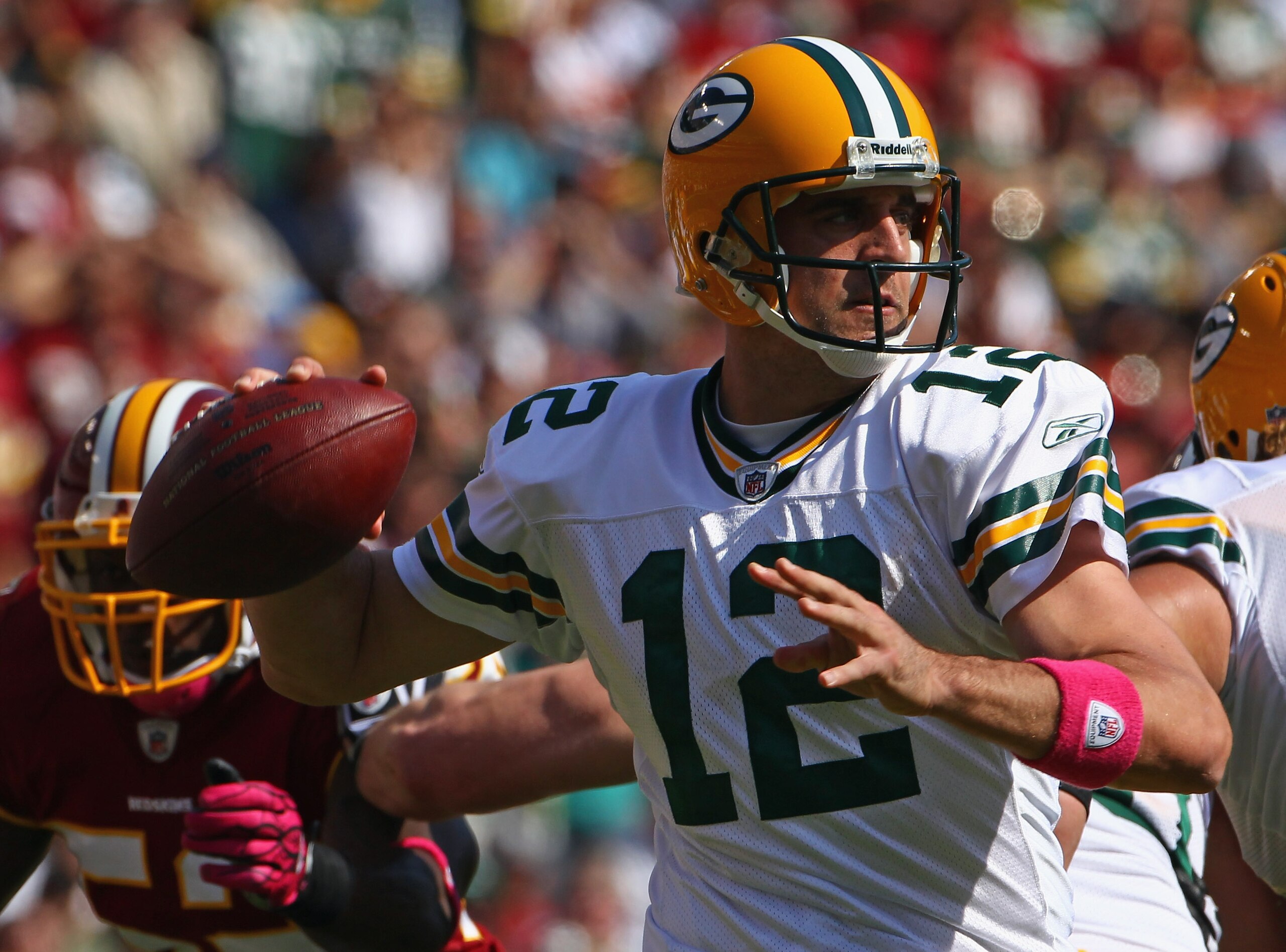 LANDOVER, MD - OCTOBER 10: Quarterback Aaron Rodgers #12 of the Green Bay Packers drops back to pass against the Washington Redskins at FedExField on October 10, 2010 in Landover, Maryland.  (Photo by Win McNamee/Getty Images)