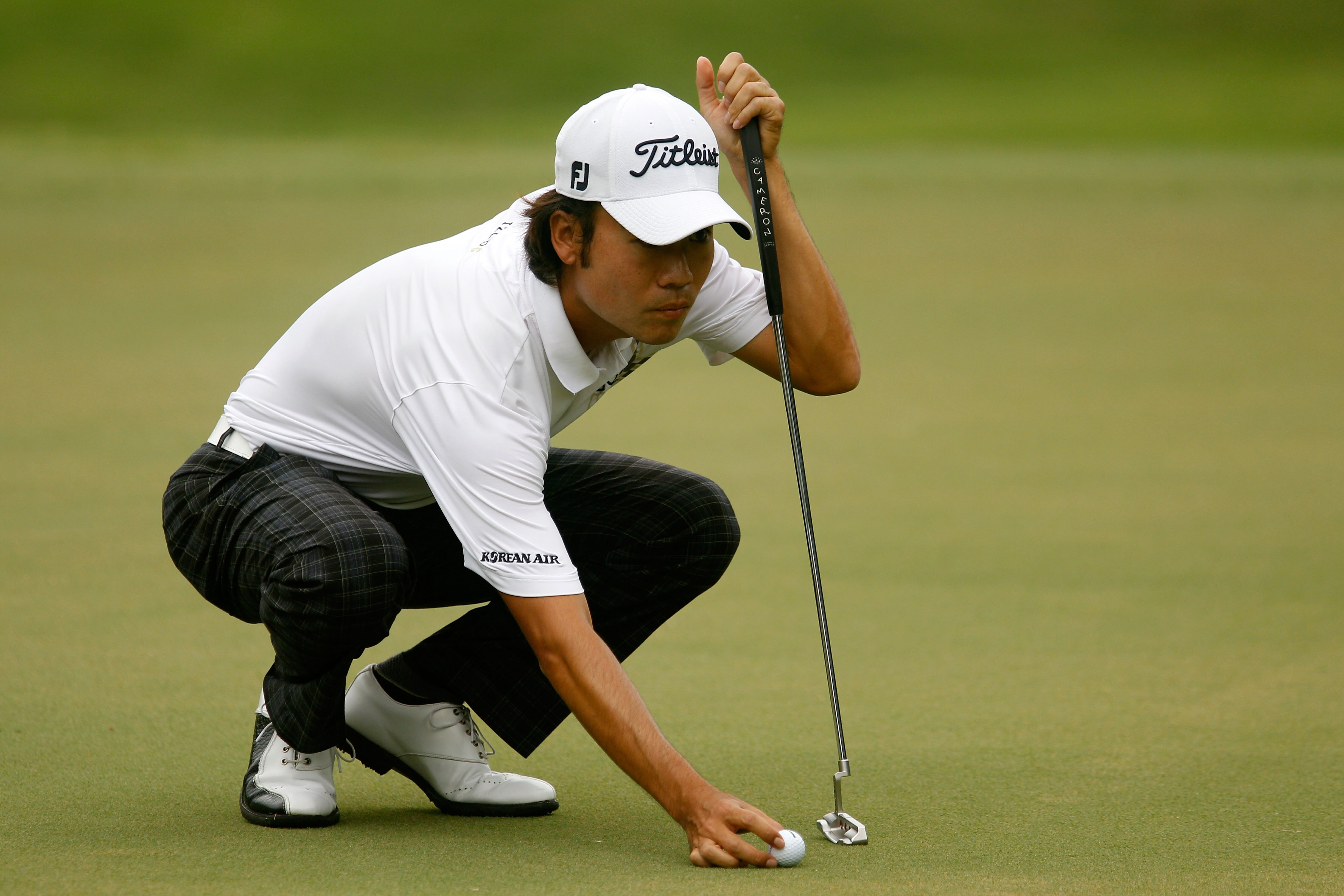 ATLANTA - SEPTEMBER 26:  Kevin Na places his ball on the second green during the final round of THE TOUR Championship presented by Coca-Cola at East Lake Golf Club on September 26, 2010 in Atlanta, Georgia.  (Photo by Scott Halleran/Getty Images)